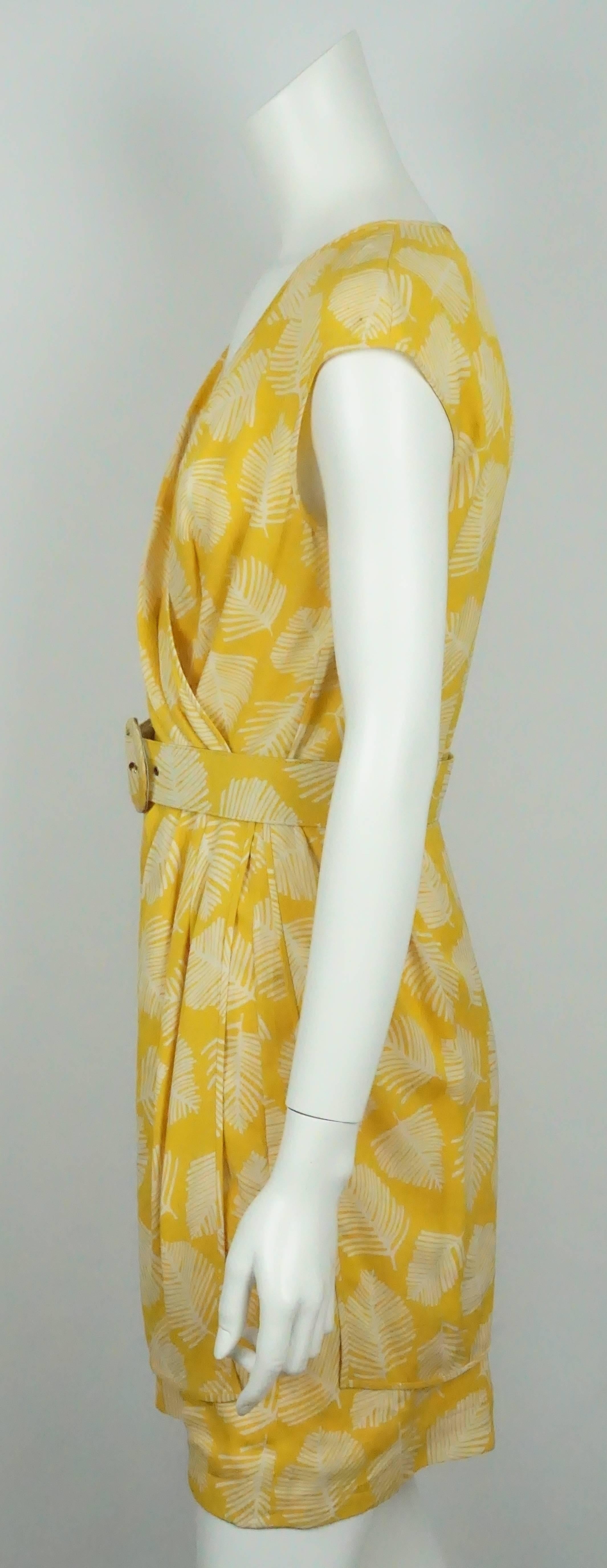 Valentino Yellow & White Cap Sleeve w/ Leaf Print - 8  This gorgeous silk blend dress is in good condition. There are some minor spots on the left shoulder. The dress has cross front that creates a v neck. It has the illusion of a wrap around dress.