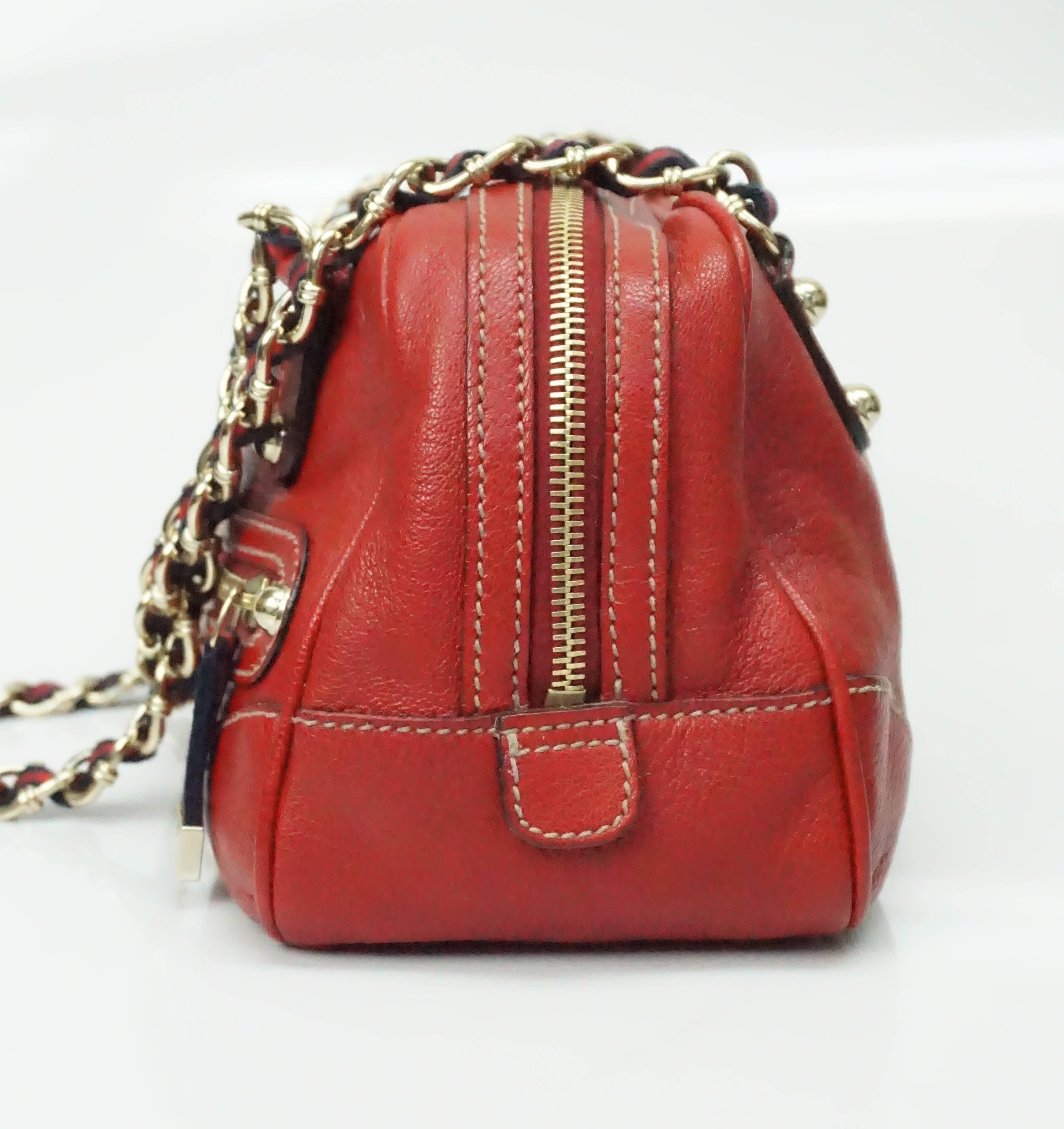 Gucci Red Leather Capri Boston Shoulder Handbag - GHW  This very stunning red Gucci handbag is truly one of my favorites. It has 2 chain large link shoulder straps that have the blue and red stripe Gucci ribbon running through it. The same ribbon