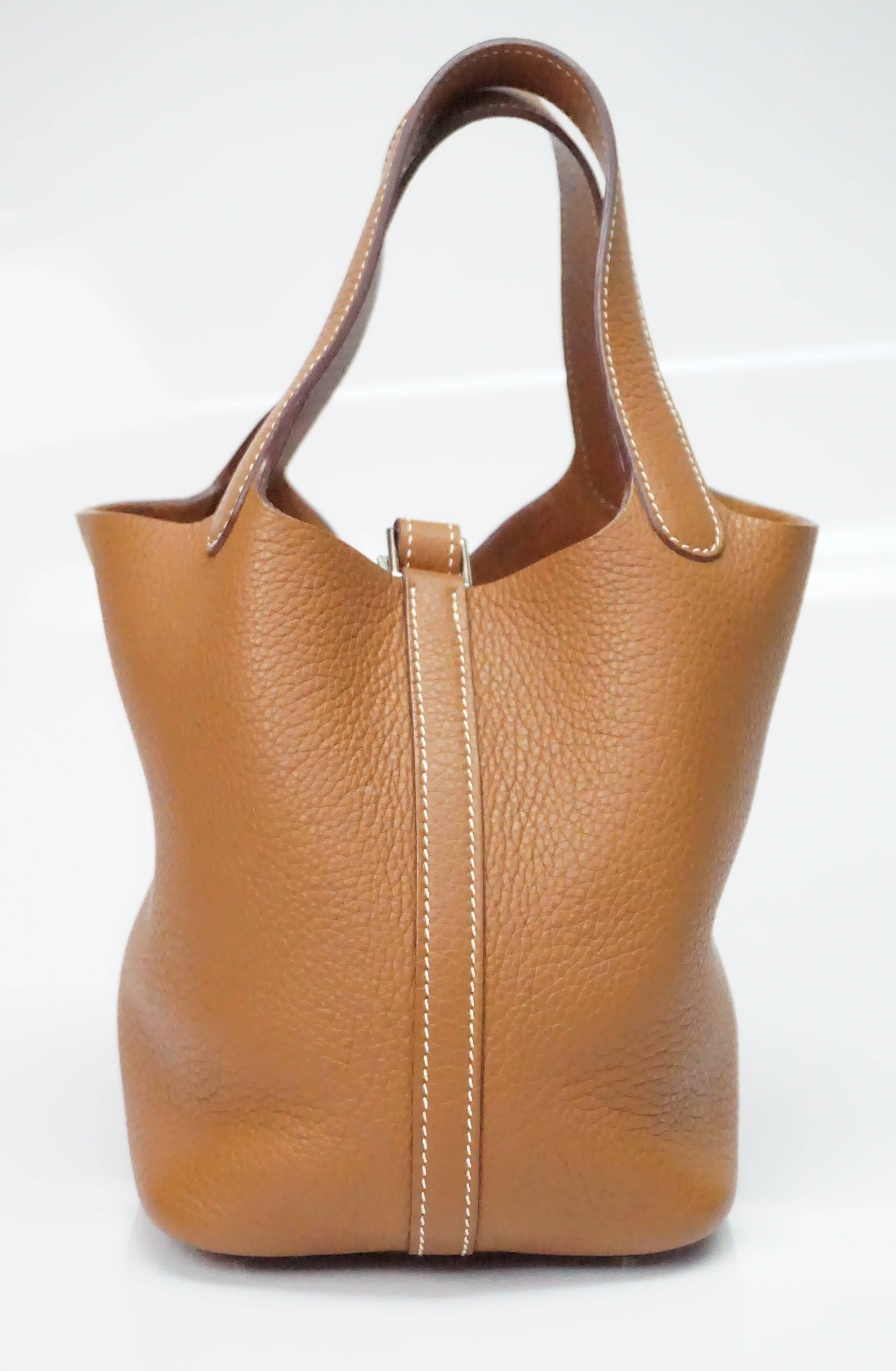 Hermes Gold Leather Picotin Lock PM Bag SHW - 2009  This Hermes Picotin is in excellent condition. It has two handles, white/ivory stitching throughout the bag with SHW. It has one main compartment and closes with an inside buckle type strap. It has