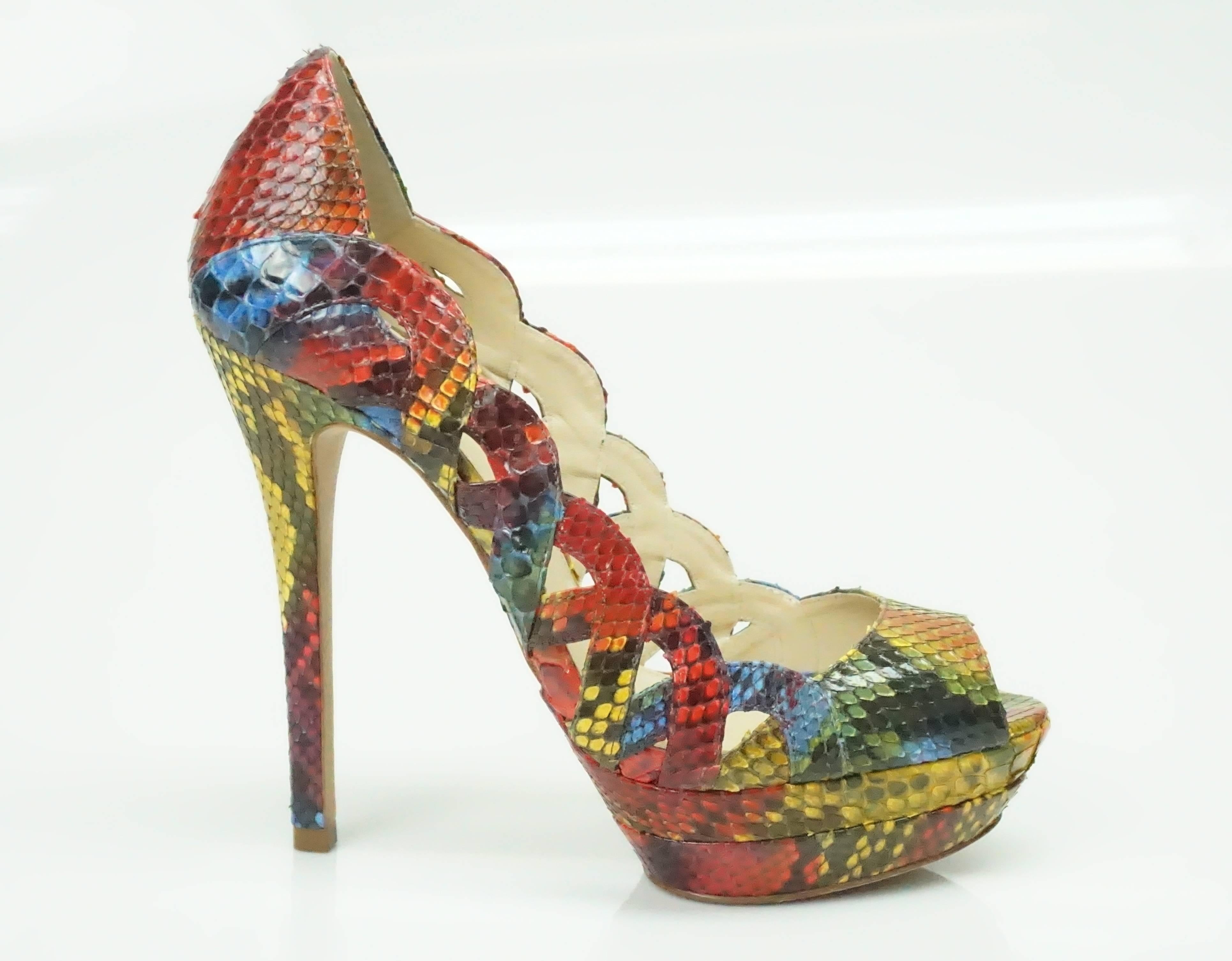 Alexandre Birman Multi Color Python Peeptoe Platform Heel - 8  These truly spectacular heels are a must have for any fashionista. They have scalloped cutout details on the sides, are peeptoe and have a very high almost spike heel. The colors on the