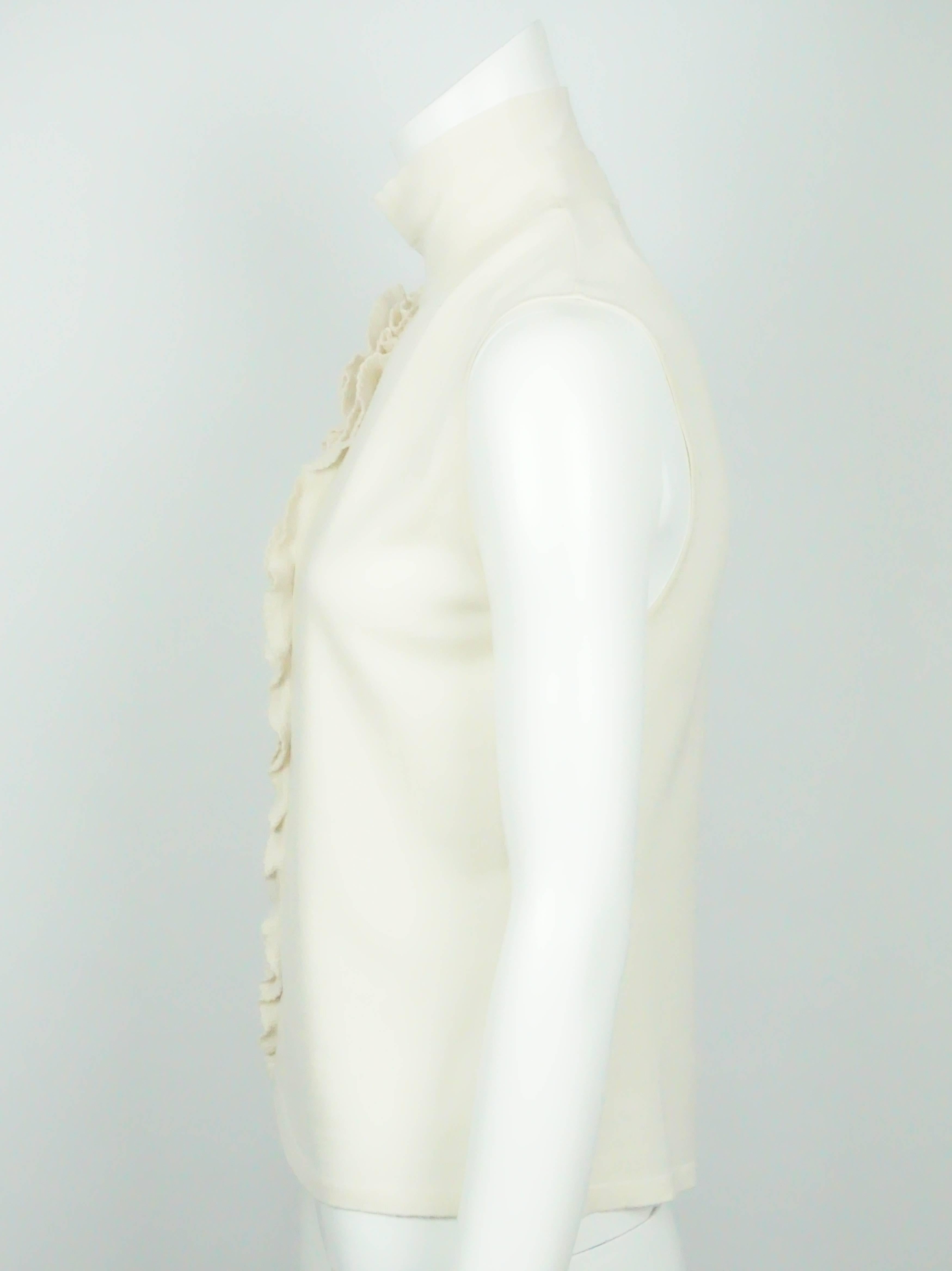 Valentino Cream Knit Sleeveless Top - Medium  This beautiful fleece wool top is in excellent condition. The top has a turtle neck collar and has no sleeves. It is embellished with a beautiful floral detail which is made of kit material and has a
