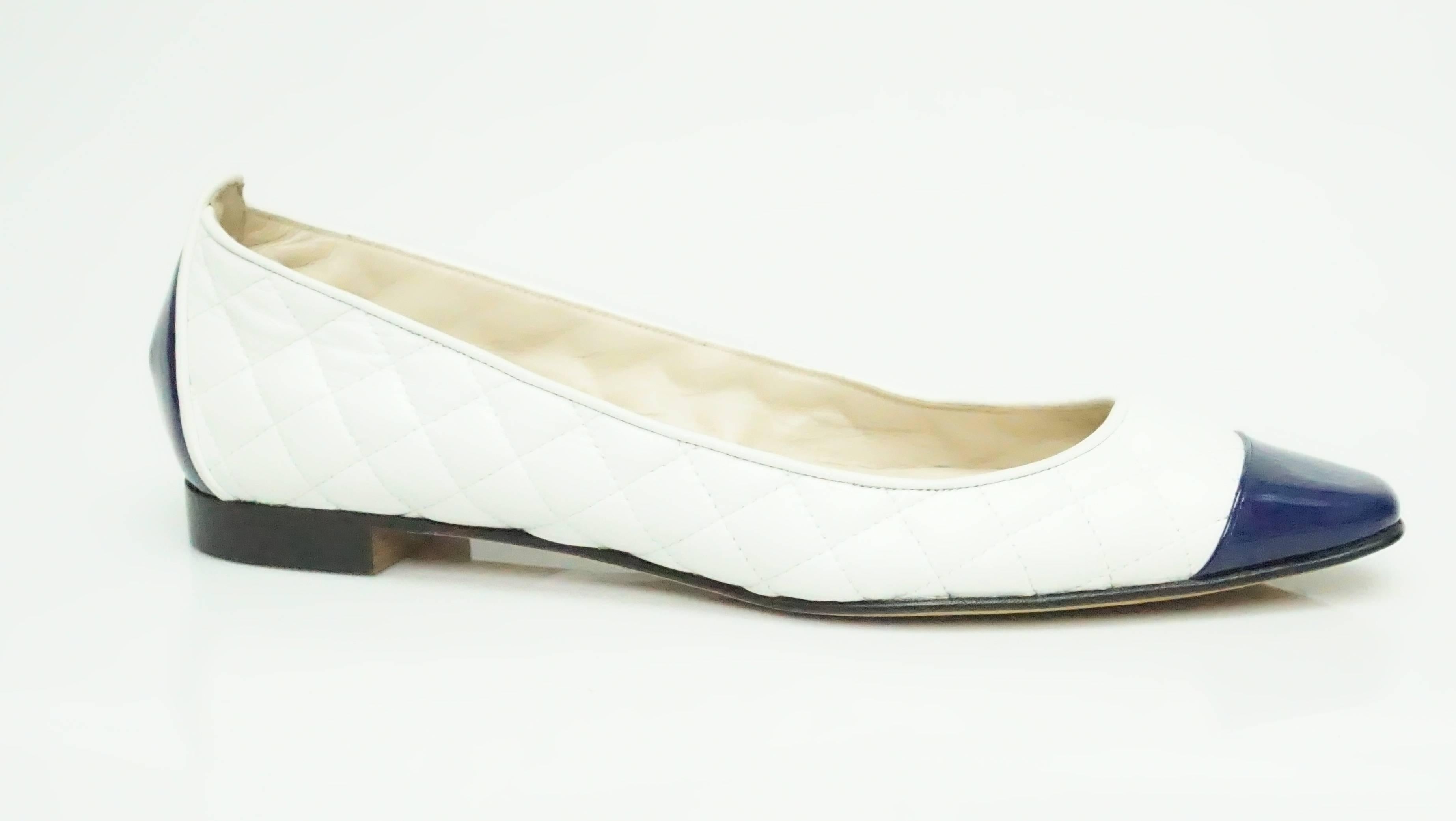 Manolo Blahnik White Quilted and Navy Toe Flat - 38  These classic looking flats are in excellent condition. They have a quilted look to them and the toe is a bold royal blue made of patent leather. The back of the heel has the same blue detail as