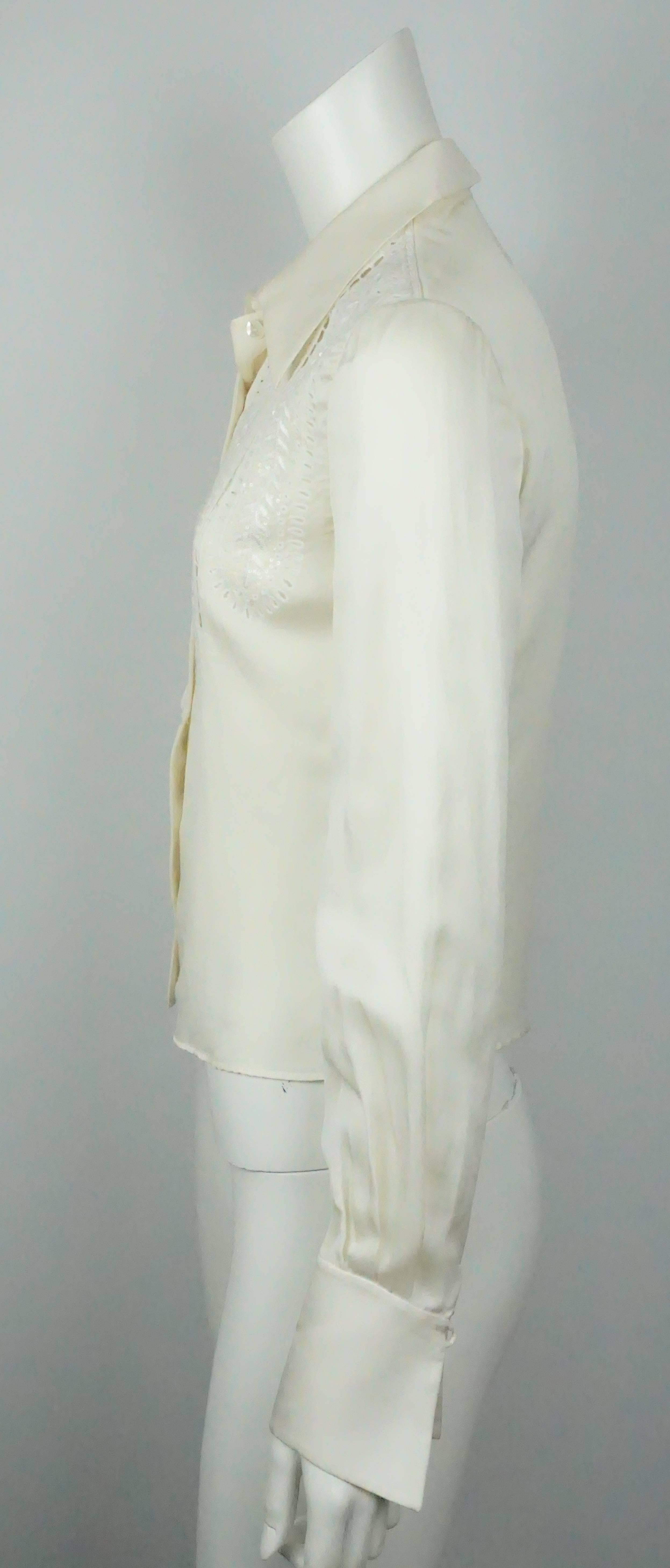 Valentino Ivory Silk Long Sleeve Top w/ Eyelet Detail - 4   This beautiful silk top is in excellent condition. The sleeves have a slight peasant sleeve effect to it and the cuffs have a dramatic detail to them. The eyelet detail on the front of the