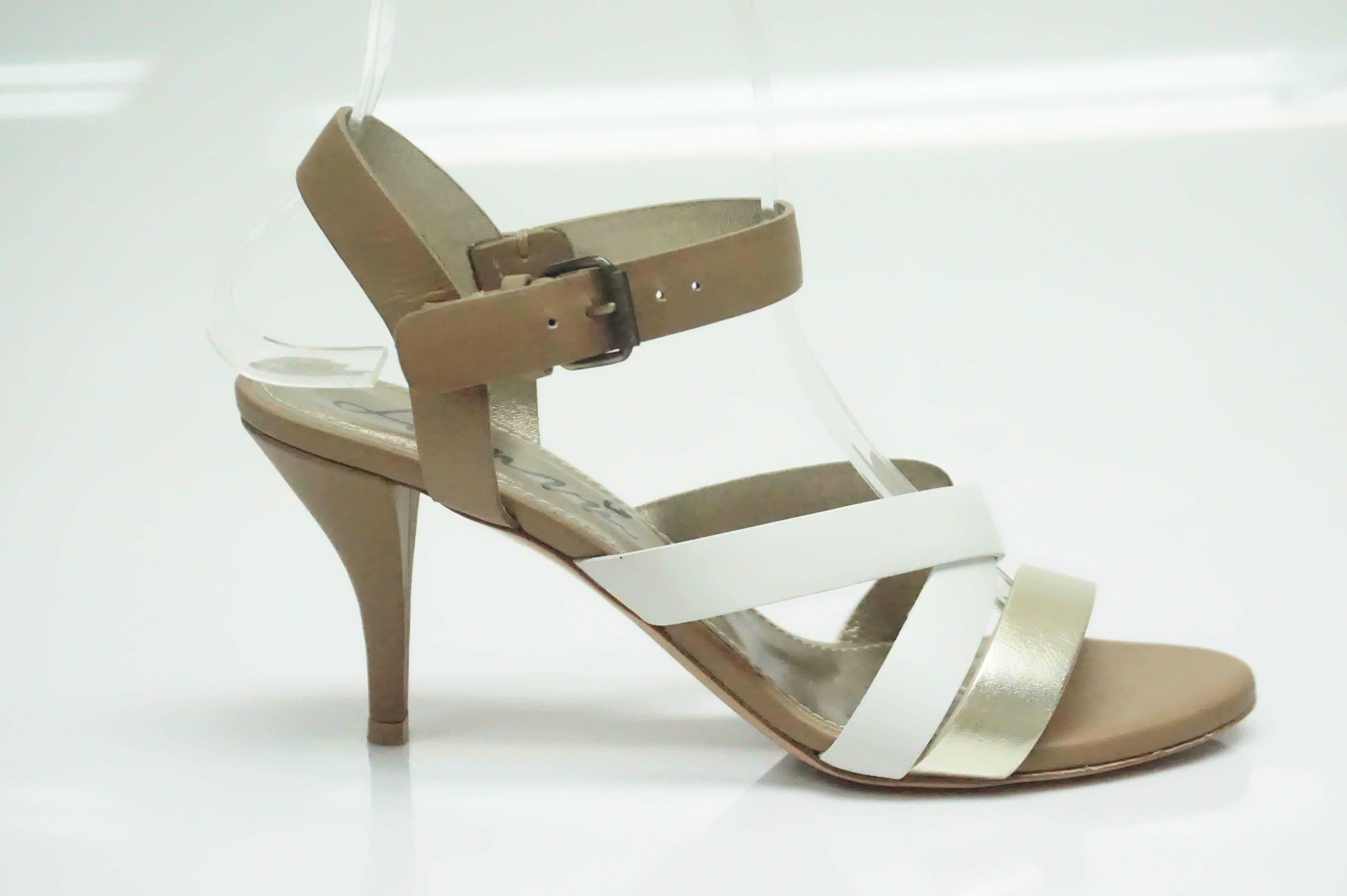 Lanvin Brown/White/Metallic Gold Strappy Heel - 37  This beautiful heel is in excellent condition. The shoes have a white, brown, and metallic color to the straps. There is a buckle to adjust the ankle strap. 
Measurements
Heel Height: 3.5