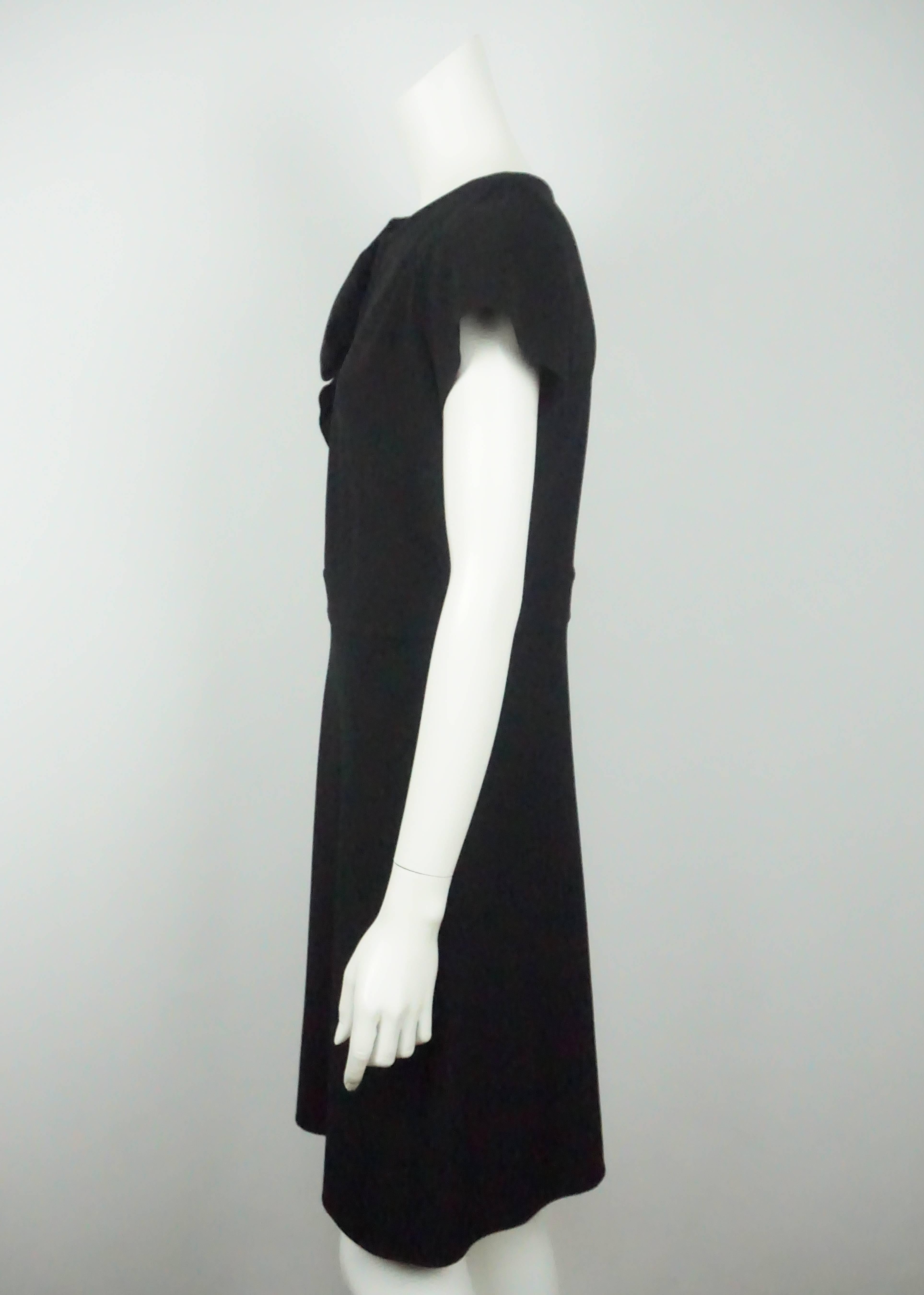 Valentino Black Short Sleeve Dress w/ Rose Detail - 8  This viscose and nylon dress is in good condition. The dress has a beautiful rose detail that is made from the same material as the dress. It has a long side zipper and there are four hook and