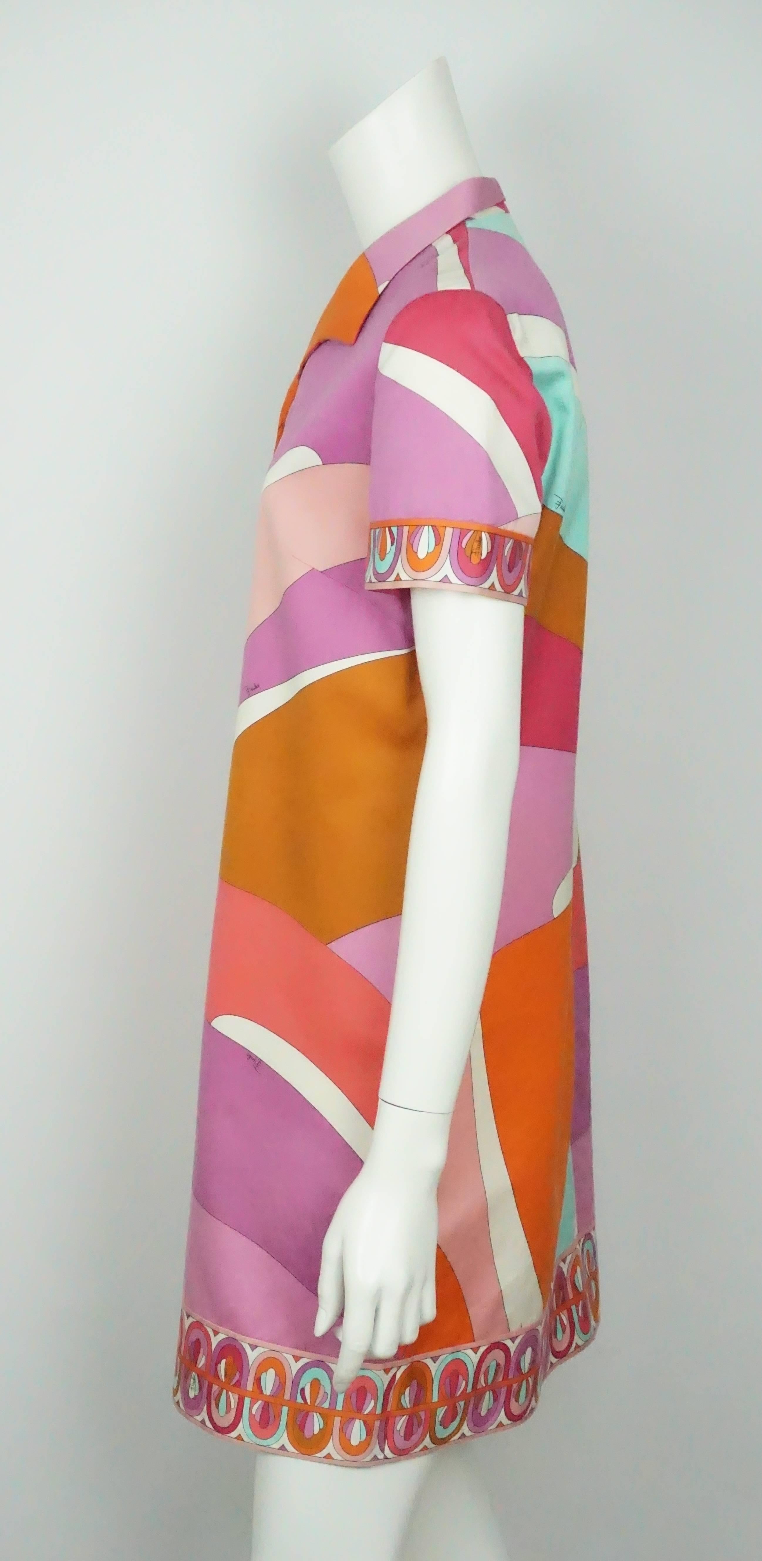 Emilio Pucci Multi Color Cotton Short Sleeve Shirt Dress - 10  This beautiful cotton shirt dress is made primarily of pinks, purples, oranges, teal and white. It has a beautiful printed band along the sleeves, bottom of dress and the front of the