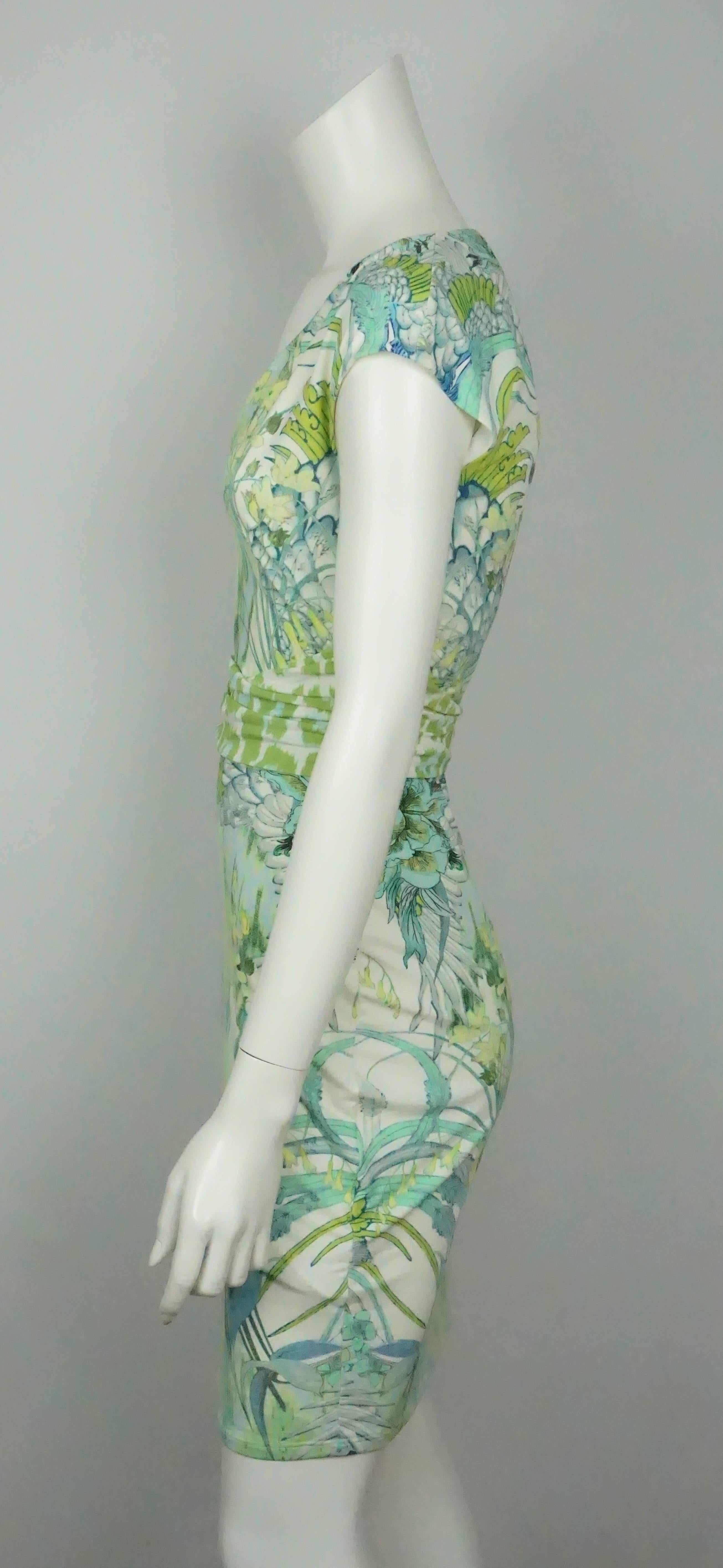 Roberto Cavalli White and Green Print Jersey Short Sleeve Dress - 40  This great summertime dress is lined to under the bust area and has a V neckline. The dress has cap sleeves and a 4.75
