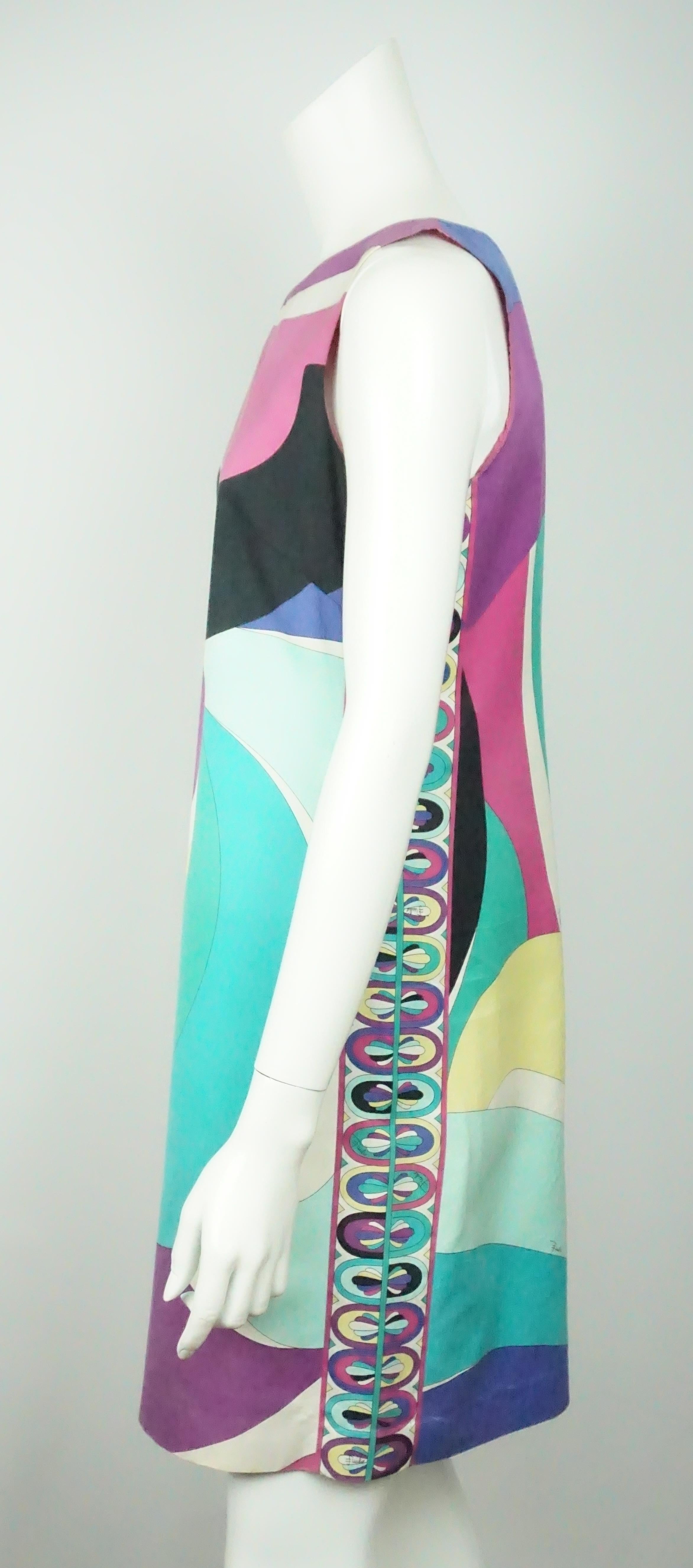 Emilio Pucci Sleeveless Shift Dress - 10  This classic cotton Pucci dress is in good condition. There are beautiful colors on this dress including purples, blues, green, and yellow. The dress is a simple shift dress with the classic Pucci pattern.
