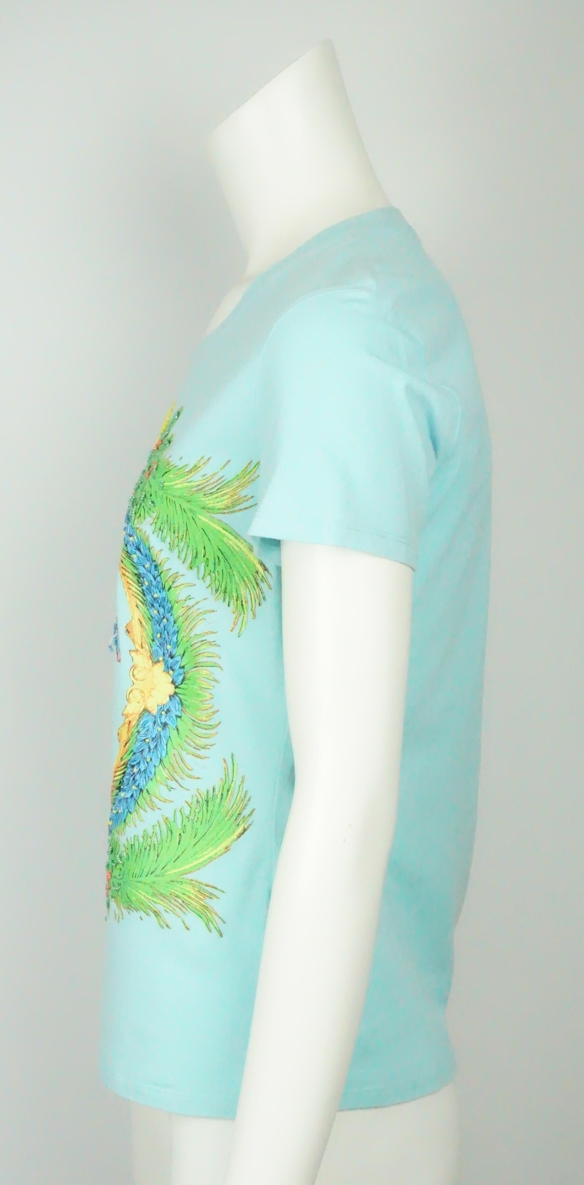 Versace Jeans Couture Baby Blue Shirt w/ Beading and Tropical Print - XL  This beautifully unique t-shirt is in excellent condition. The shirt is made completely out of cotton. There is a unique design on the front of the top that consists of palm