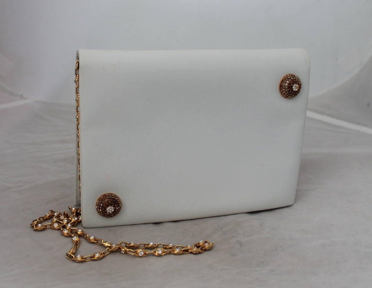 Valentino 1980's White Evening Bag with Rhinestone Detail & Chain. This bag is in excellent vintage condition with wear consistent with age. There is one rhinestone missing on the circular design seen on image 3. The chain is gold with rhinestones.