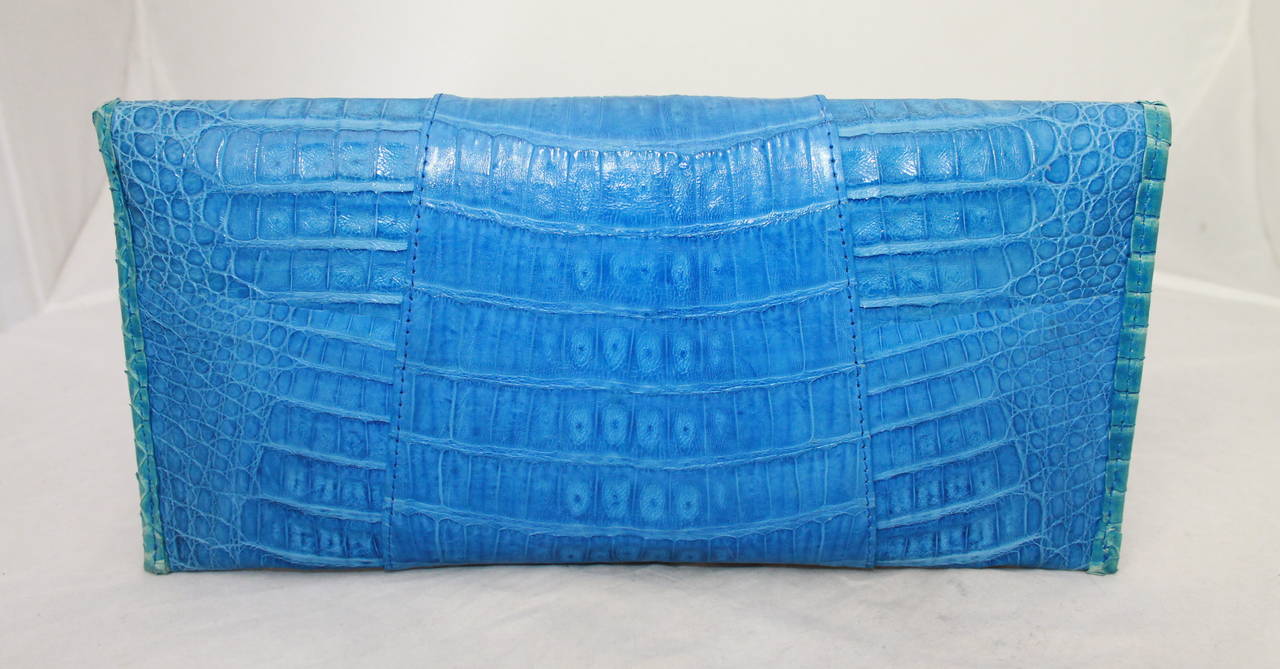 Carlos Falchi Blue Alligator Clutch & Handbag. This bag is in excellent condition with nearly no signs of wear. It is lined in suede and lambskin and has a silver chain that is shoulder length. 

Measurements:
Length- 5.5