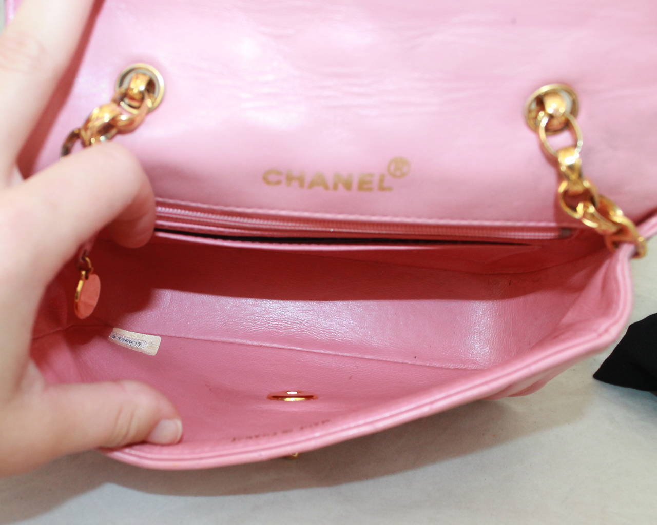 Chanel 1990's Pink Quilted Lambskin Handbag GHW - circa 1991. This bag is in fair vintage condition with wear consistent with being 24 years old. It has a quilted gold chain unique to the 1990's Chanel handbags. The bag has wear on the leather on