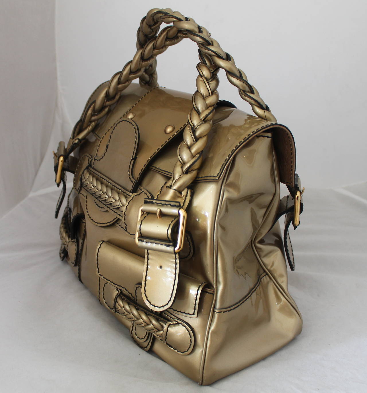 Valentino Gold Patent Leather Handbag with Braiding - rt. $1795. This bag is in excellent condition with no visible signs of wear. 

Measurements:
Length- 11