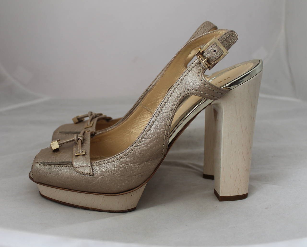 Versace Metallic Tan Peep-toe Platform Heels - 40. These shoes are in fair condition with wear on the bottom and on the sole. There is one black scratch on the bottom of the left shoes (image 3) but cannot be seen unless closely inspected.
