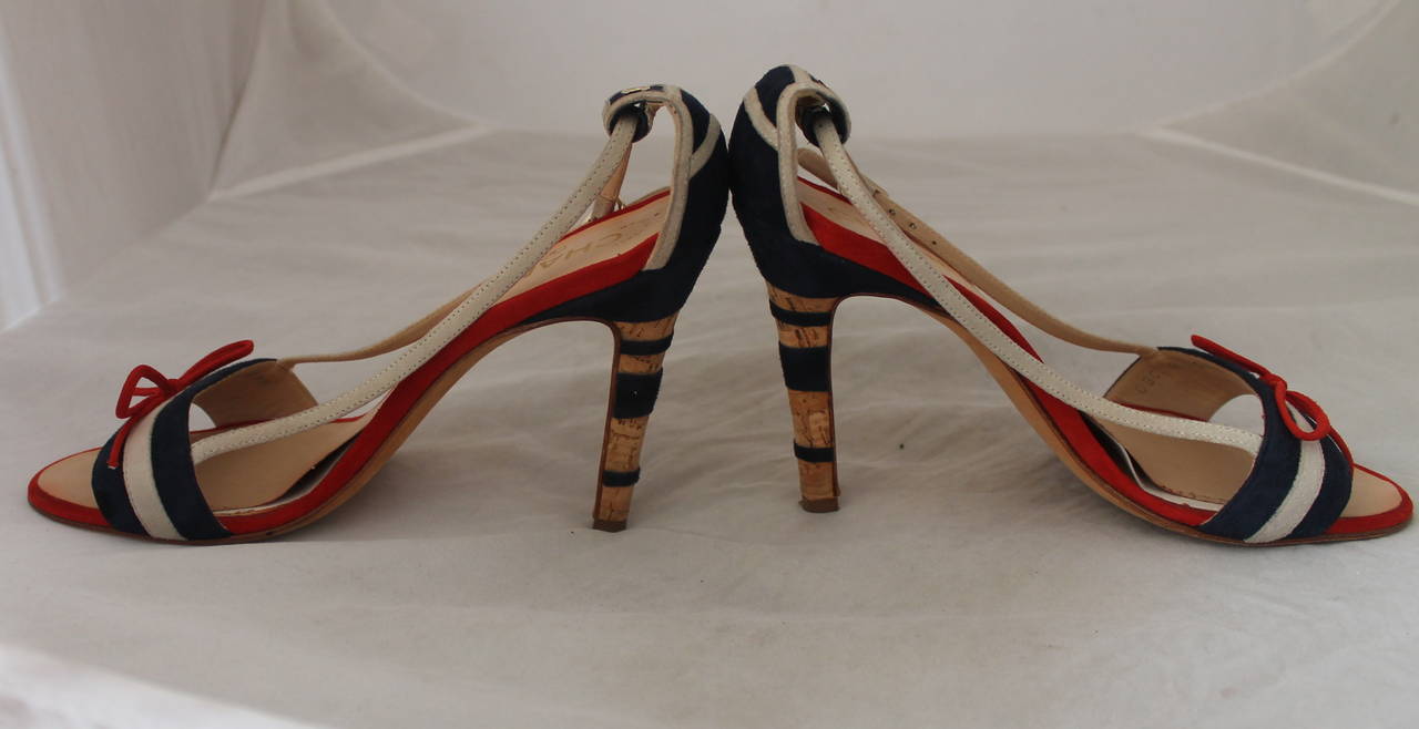 Chanel Red, White, Blue Suede Cork Heels - 38.5. These shoes are in fair condition with wear on the bottom and the sole. There is an area on the sole on both shoes that is lifted (image 3 & 4).