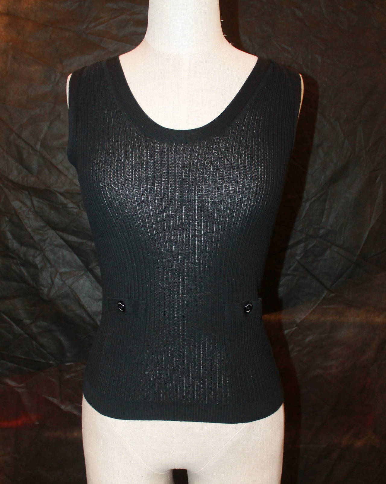 Chanel Black Knitted Sleeveless Top- 34. This top is in very good condition with little wear. It has two pockets in the front. The fabric expands and becomes larger and it's from 2007. 

Measurements:
Bust- 24