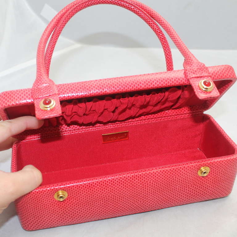 Judith Leiber Red Karung Snake Handbag - Circa 70's Item is in excellent vintage condition. Has the change purse, mirror and comb. Snap front with jeweled detail. Top handle bag. 
Measurements:
Height 3