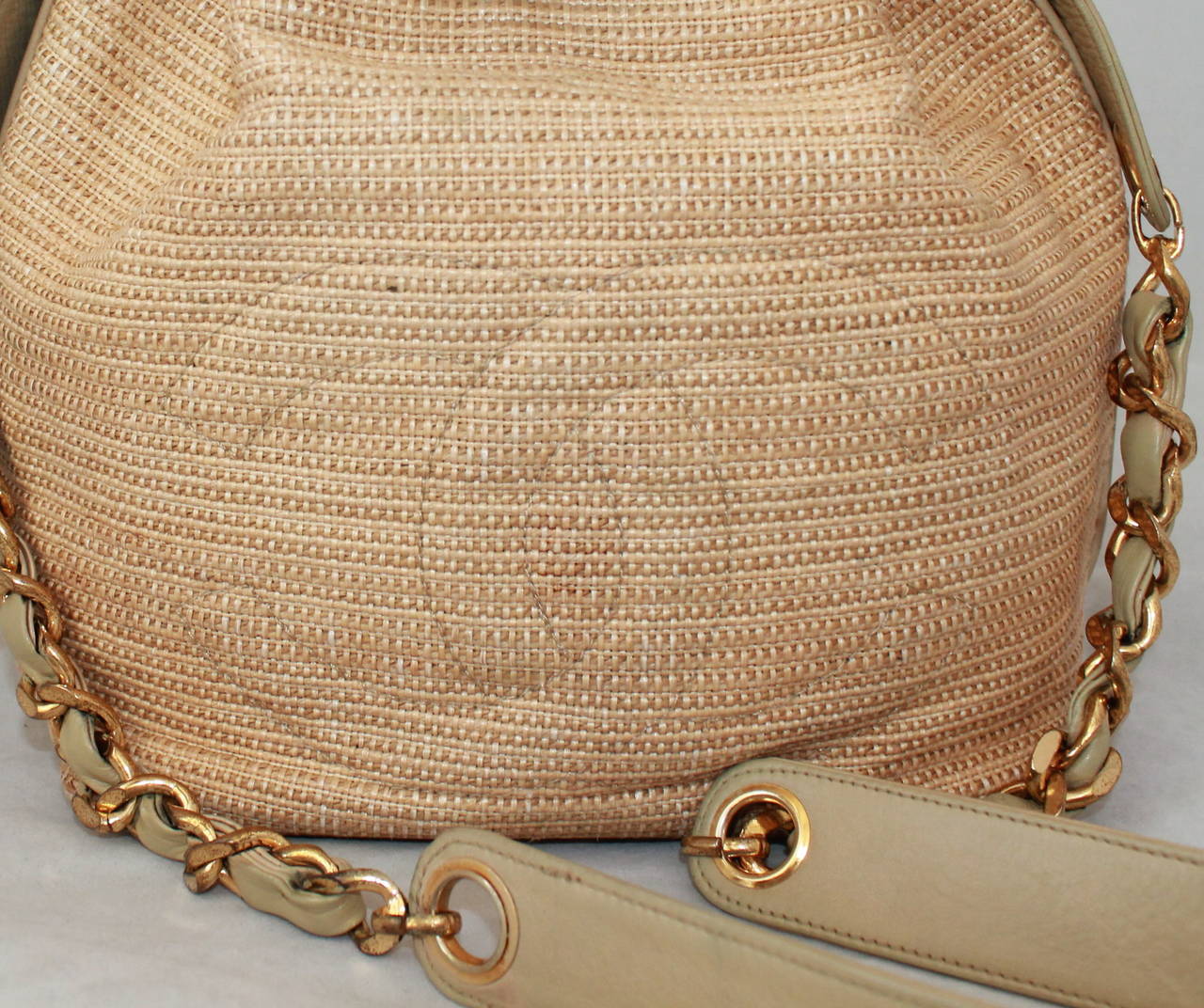 Chanel Early 1980's Vintage Raffia & Beige Leather Crossbody Bag. This bag is in good vintage condition with the raffia showing very minimal use but the inside displaying signs of use. It comes with a smaller case inside. 

Measurements:
Length-