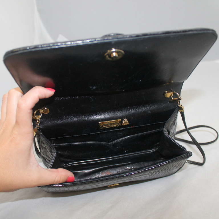 Judith Leiber Black Alligator Skin Clutch with Diamond & Black Buckle. This bag is in excellent condition and comes with a strap.
Measurement:
Height- 5