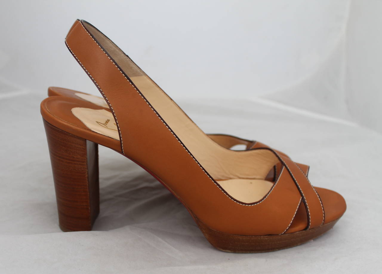 Christian Louboutin Luggage Tone Leather Woodstack Heel - 42. These shoes are in good condition with minor wear on the leather but visible wear on the sole.