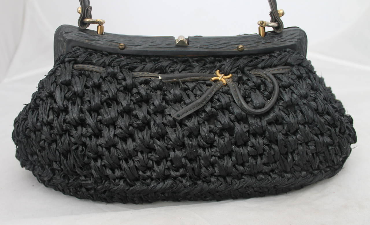 1950's Vintage Italian Black Straw Top Handle Bag. This bag is in very good vintage condition with wear consistent with its age.

Measurements:
Length- 7