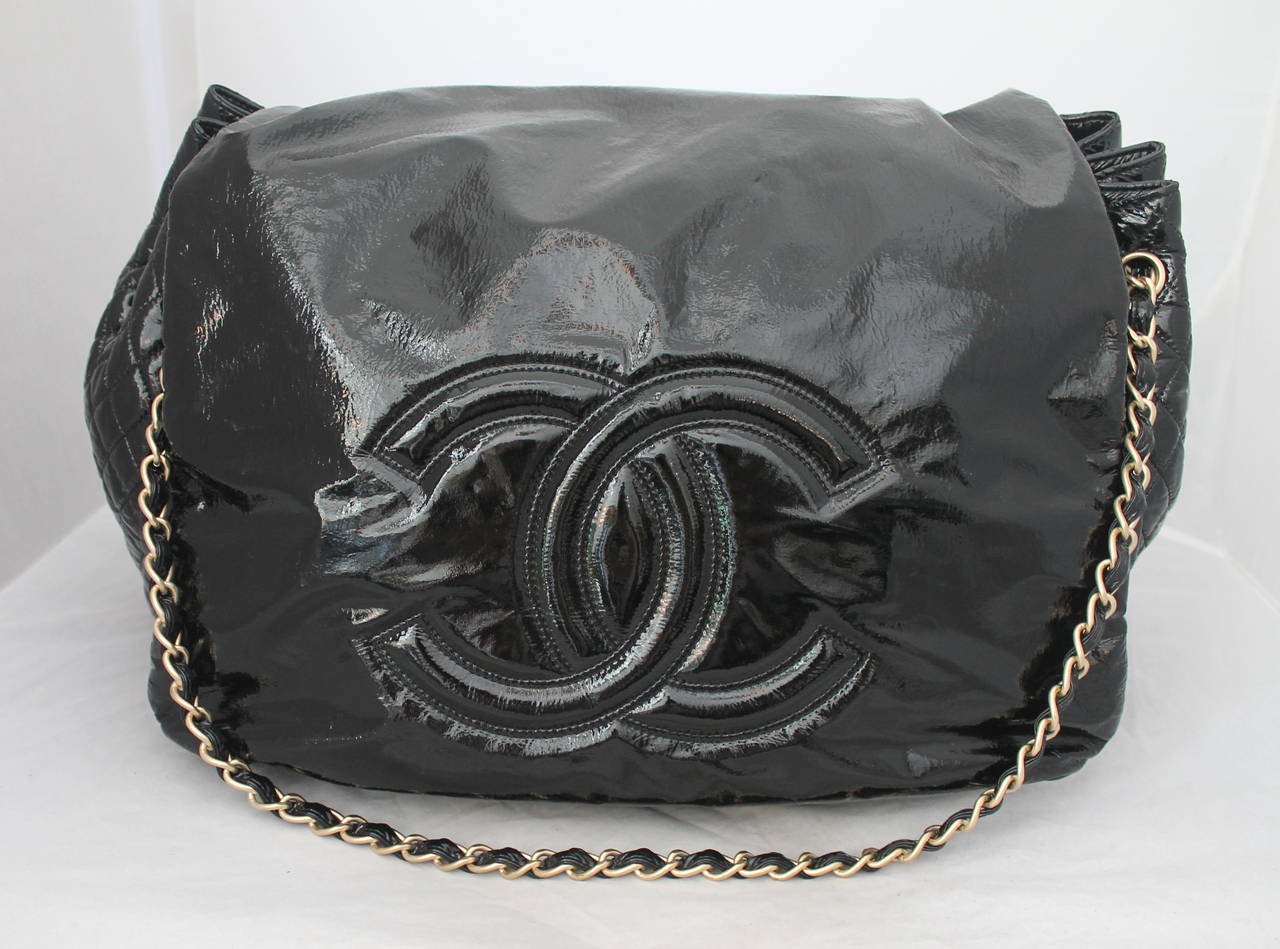 Chanel Black Patent Leather Rock and Chain Flap Handbag circa 2007. This bag is in excellent condition and comes with a box, components, and tags still attached. The chain can be made longer.

Measurements:
Length- 15