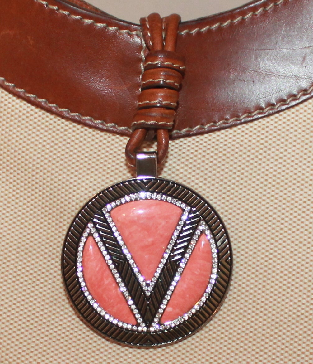 Valentino Creme Canvas and Brown Leather Trim Shoulder Bag with Coral enamel and Rhinestone Medallion. Bag is in good condition however there are some light yet visible scratches on the leather trim and light wear to the