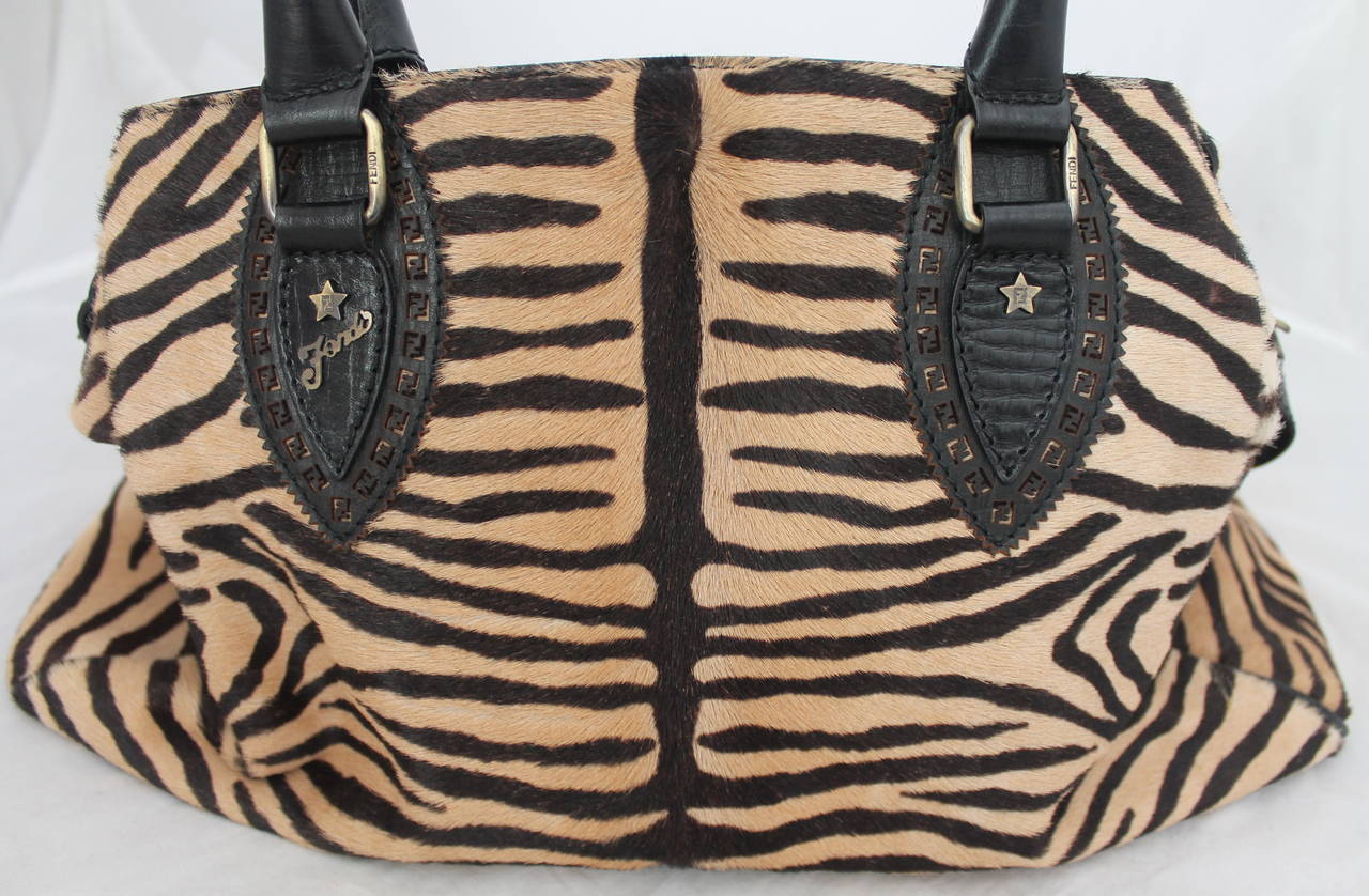 Fendi Black & Beige Zebra Printed Pony Hair Handbag. This handbag is in excellent condition with minor use. It also has a classic Fendi print lining. 

Measurements: 
Length- 8.75
