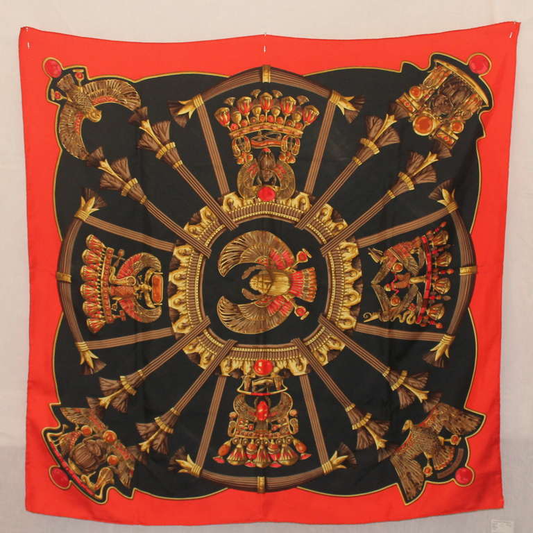 Hermes Red & Black Silk Scarf with coral/red edging and an Egyptian gold eagle crest themed print. This scarf is in excellent condition.
Measurements:
Length- 34.5