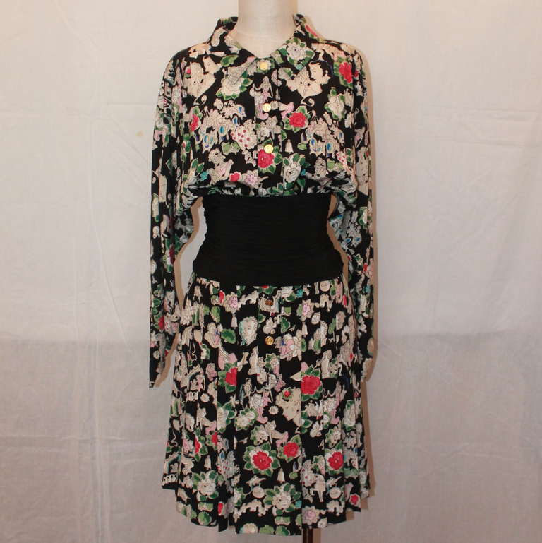 Chanel Silk Floral Print Long Sleeve Collared Dress. The print has people and flowers as scenery. The waist is black and cinched and the buttons are gold with the Chanel crest. Dress is in very good condition. Size 4.
Measurements:
Bust- up to