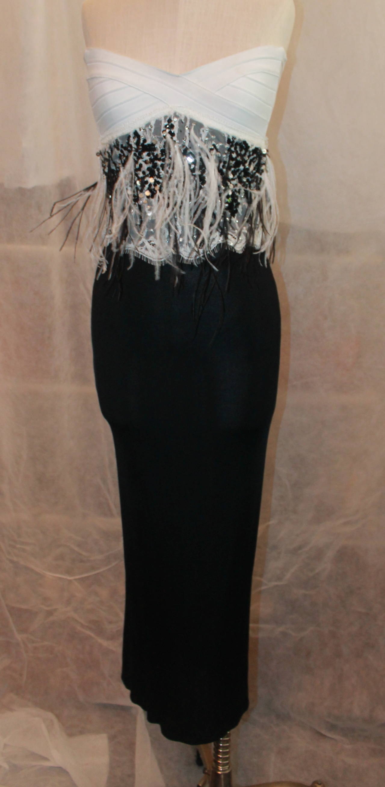 Herve Leger Strapless Black & White Gown with Sequins & Feathers - 2. This gown is in good condition with minor wear. The white top of the gown zips up and then the black portion of the gown zips on top of it. The sequin & lace detail is in the