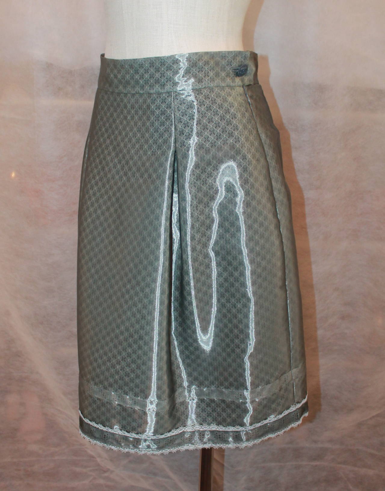Chanel 2009 Sheer Gunmetal & Lace Layered Skirt - 42. This skirt is in excellent condition and has a waistband with box pleat. It also has side pockets and zipper. The bottom has a lace bordering (image 5). 

Measurements:
Waist-