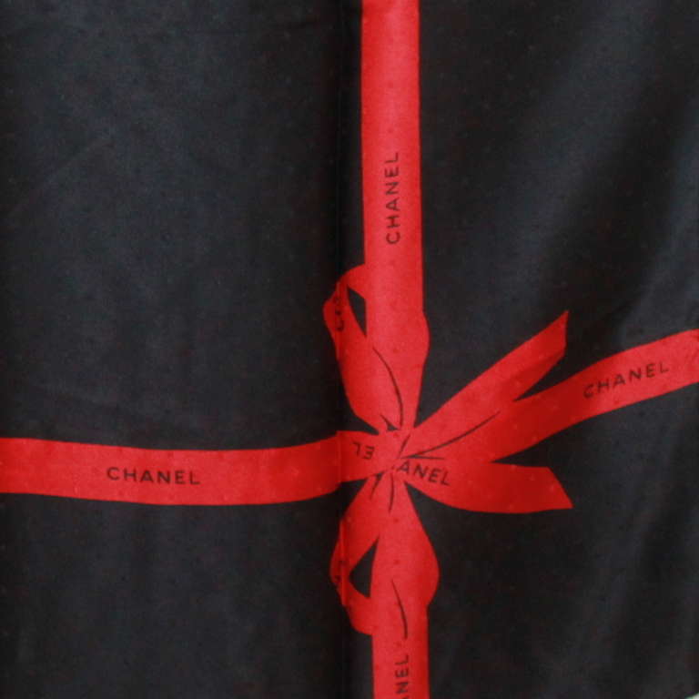 Chanel silk scarf with black background and red Chanel ribbon. Scarf is in excellent condition.
Measurements:
Length- 33.5