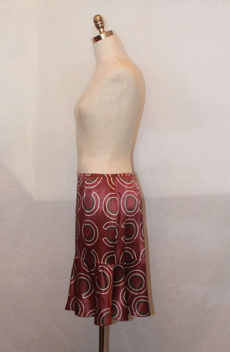 Chanel eggplant printed skirt with flare on the bottom. Print has circles and Chanel 