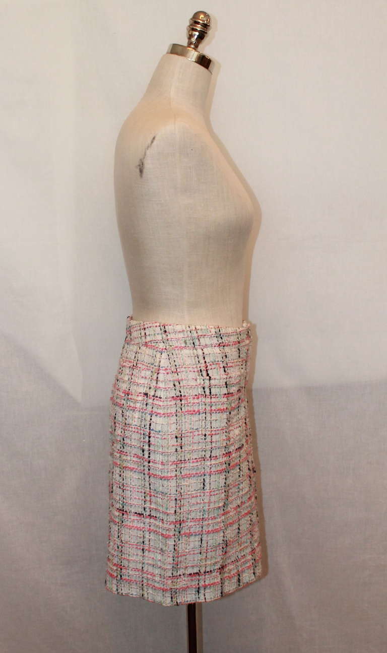 Chanel tweed skirt in pastels (pinks, blues, greens). Skirt has a pleat in the front and pockets on the back. This item is in excellent condition. Size 40. 
Measurements:
Waist- 32
