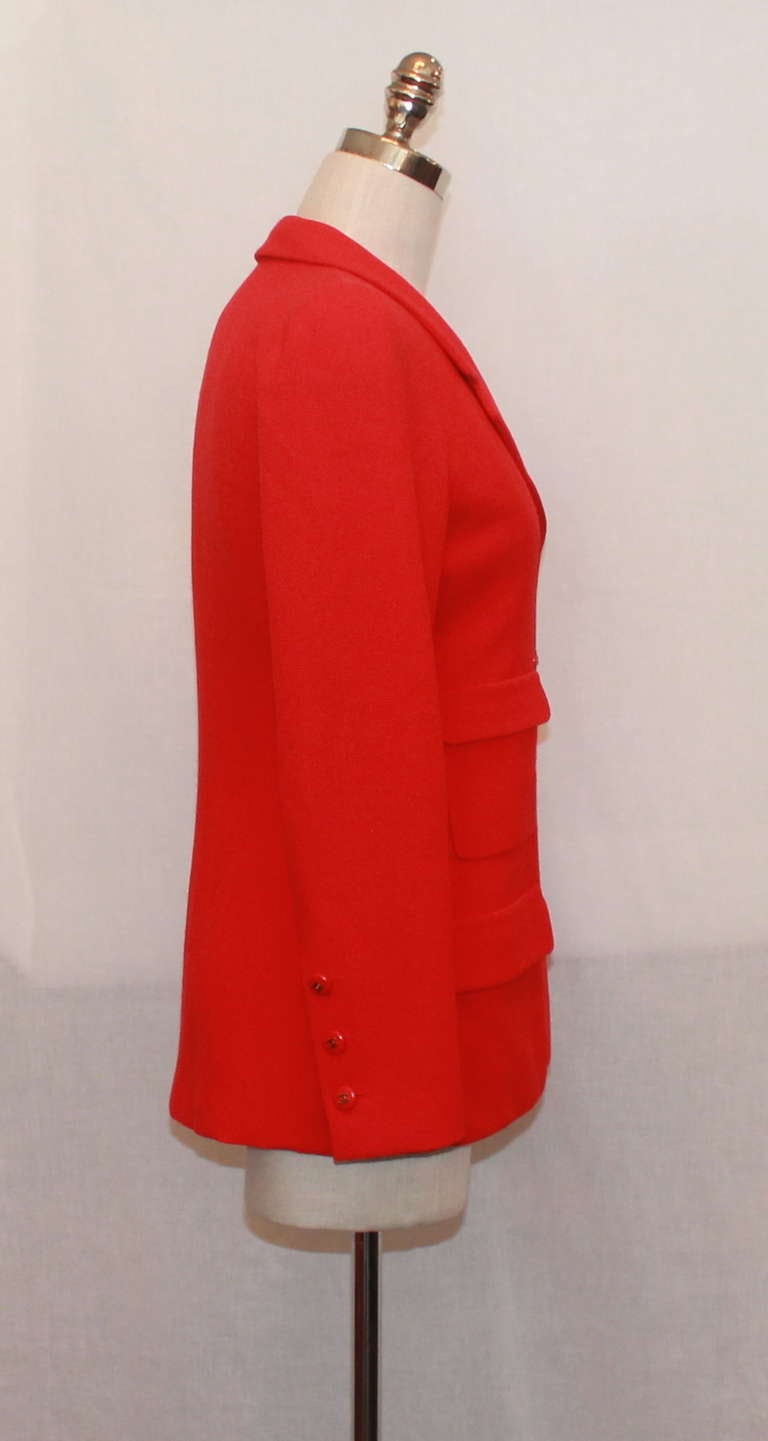 Chanel red single breasted jacket with two sets of pockets on the front. This jacket has red and gold 
