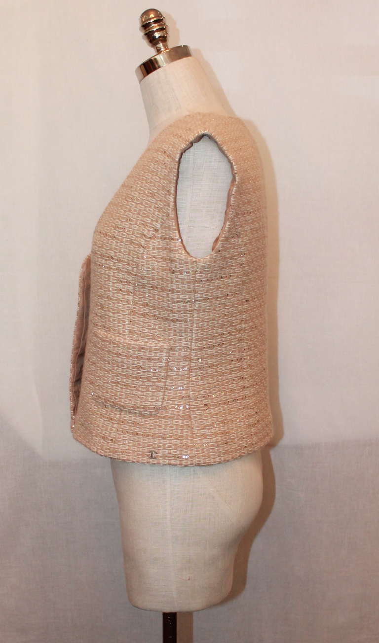 Chanel Tan & cream sequined tweed vest with pockets. Vest is in excellent condition. Circa 2000s. Size 42.
Measurements:
Bust- 34