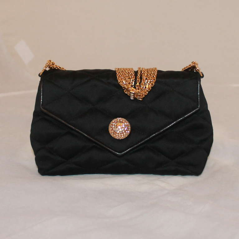 Chanel Black Satin Quilted Evening Handbag - GHW  - Circa 80's  This evening bag has one of the most beautiful gold 6 strand chain strap that rhinestone detail throughout and in the front closure. Interior is lined in red leather. This is by far the