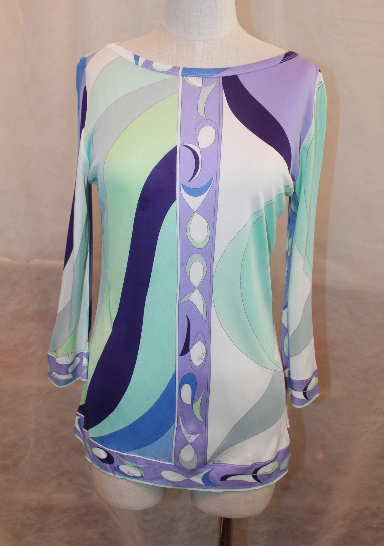 Emilio Pucci 1990's Vintage Aqua & Purple Printed Tunic Top - 12. This long sleeve top is in excellent vintage condition and is 100% rayon. 

Measurements:
Bust- 35