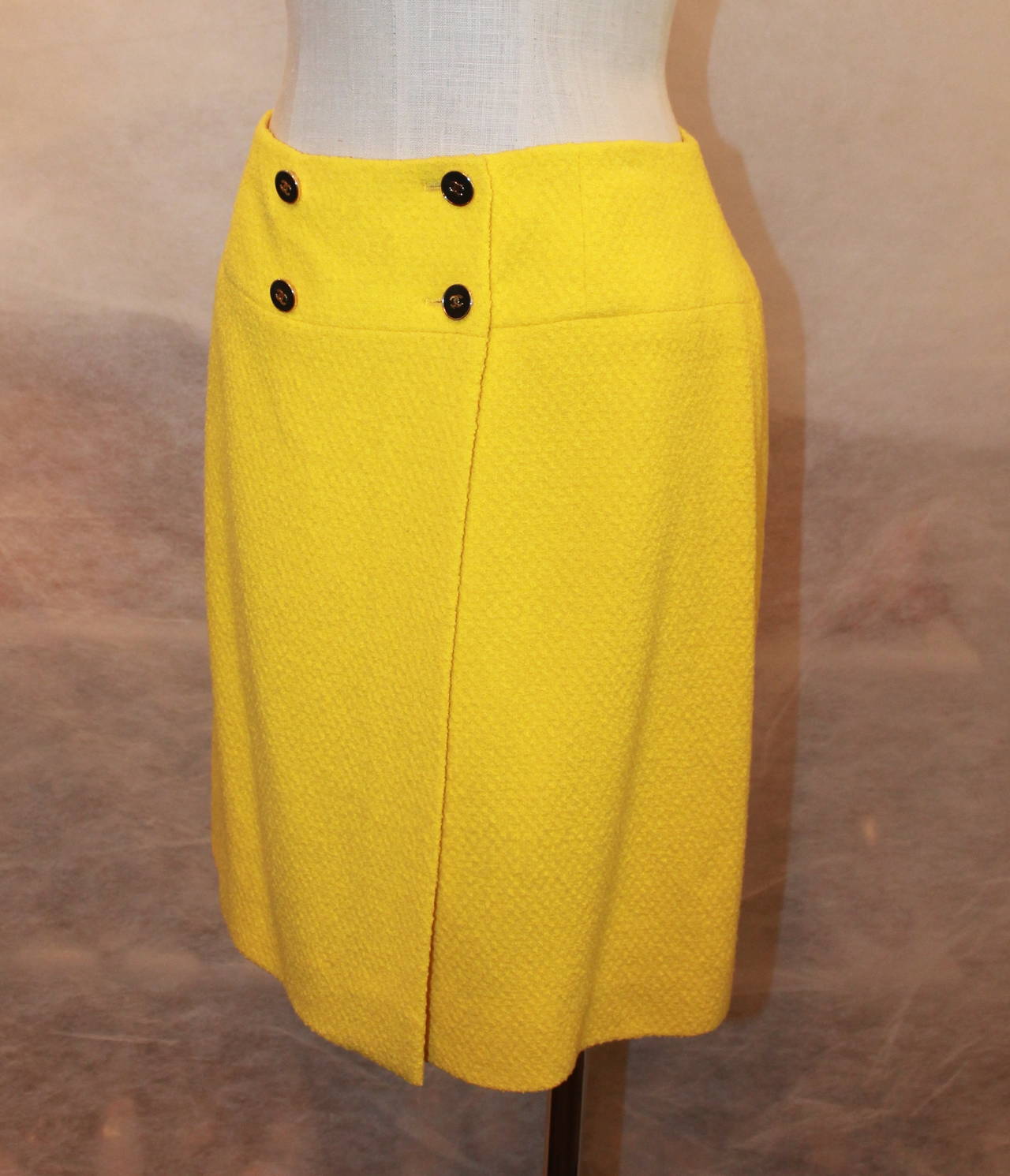Chanel 1980's Vintage Yellow Tweed Wrap Skirt - 38. This skirt is in very good condition and is 100% wool with 100% silk lining. It has 4 buttons for closure in the front. 
**There is a matching jacket in stock**

Measurements:
Waist-
