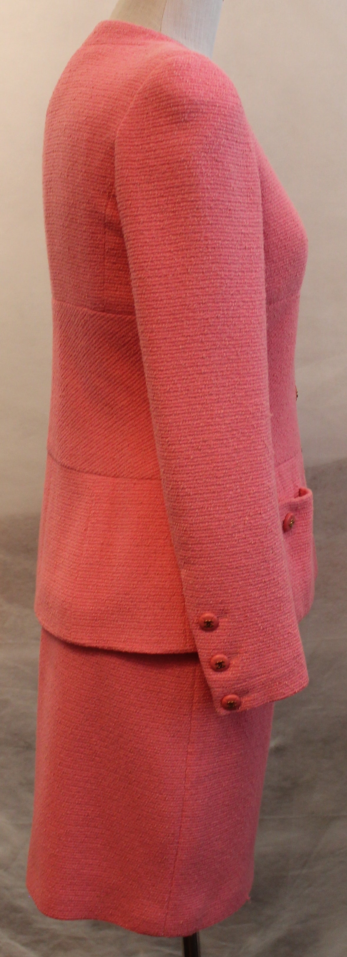 Chanel Pink Wool Classic Skirt Suit - 38 - Circa 80's
This timeless Pink Skirt suit is in very good vintage condition. It has 2 front pockets, Single breasted with 7 front buttons, Buttons on sleeves, round neck, beautiful lines on this classic
