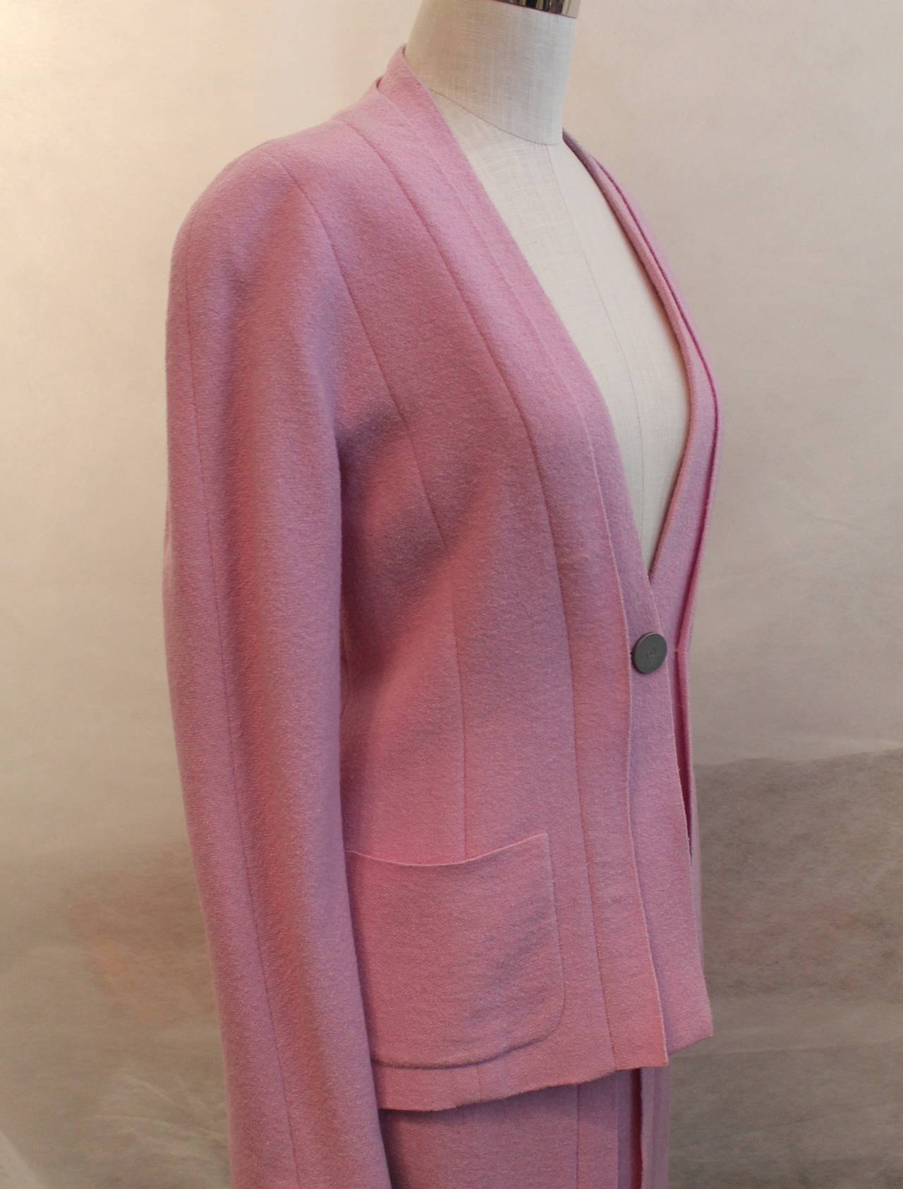 Chanel 1999 Vintage Pink/Lavender Pleated Skirt Suit - 38. This suit is in excellent condition and is 88% wool and 12% polyamide. The jacket has 2 front pockets and a vertical pleat detail. 

Measurements:

Jacket 
Bust- 36