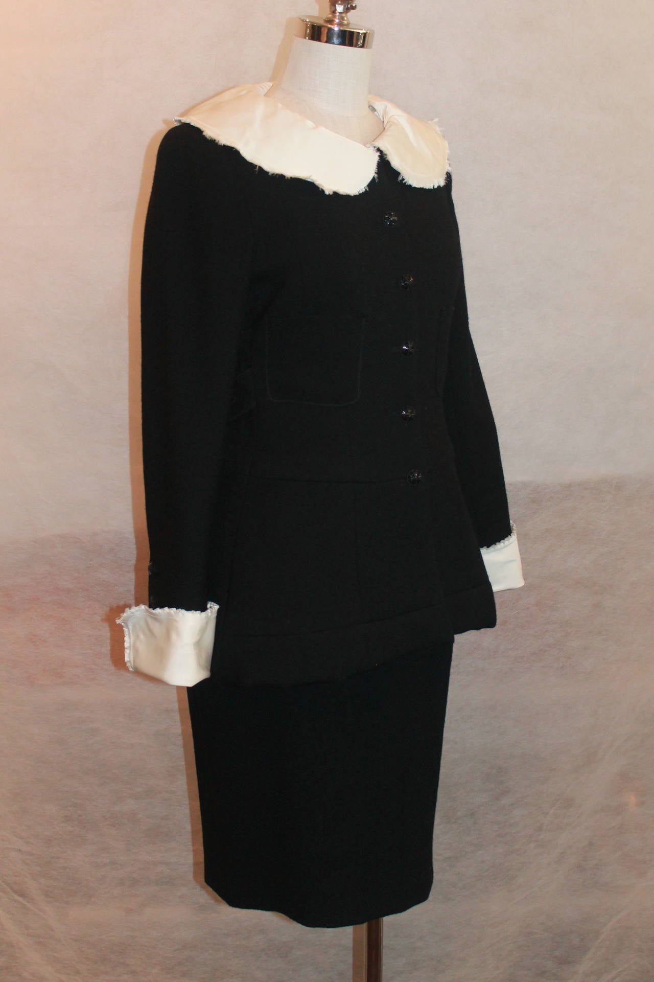 Chanel Black Wool Skirt Suit w/ removable white collar and cuffs-38-2008 collection. This very special skirt suit has white silk removable collar and cuffs w/ fringe on the ends, spectacular black w/ crystal detail buttons, 2 front pockets, the