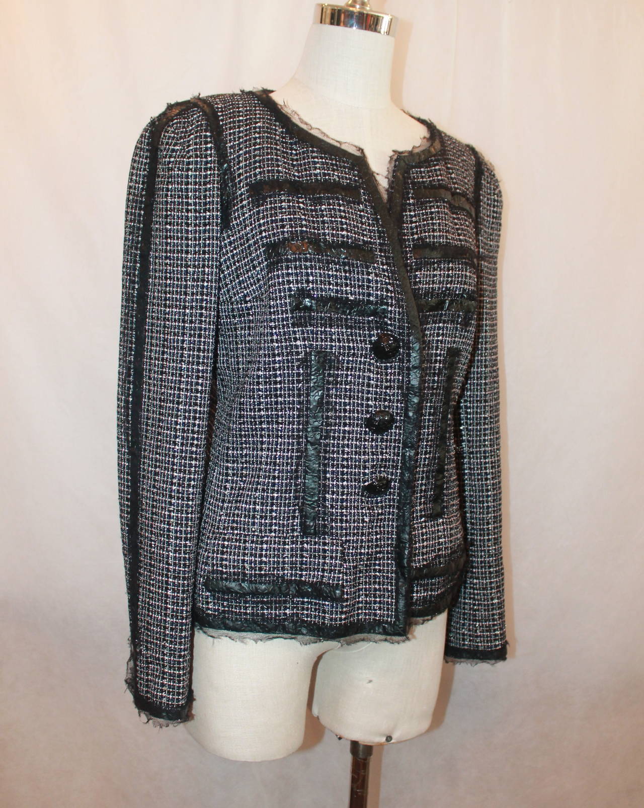 Chanel 2009 Black, White, Pink Tweed Jacket with Patent Detail - 40. This jacket is in excellent condition and is 89% nylon, 7% polyester, and 4% cotton. The tweed is a mixture of  navy, pale pink, black, white, and metallic fabric as seen on image