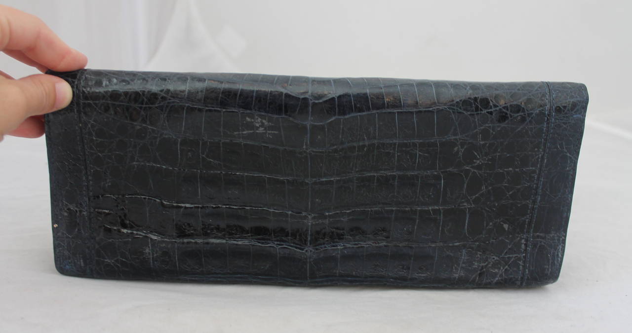 Nancy Gonzalez Navy Crocodile Wide, Skinny Fold over Clutch. This bag is in Good Condition with Minor Wear.

Measurements:
Height: 5 
