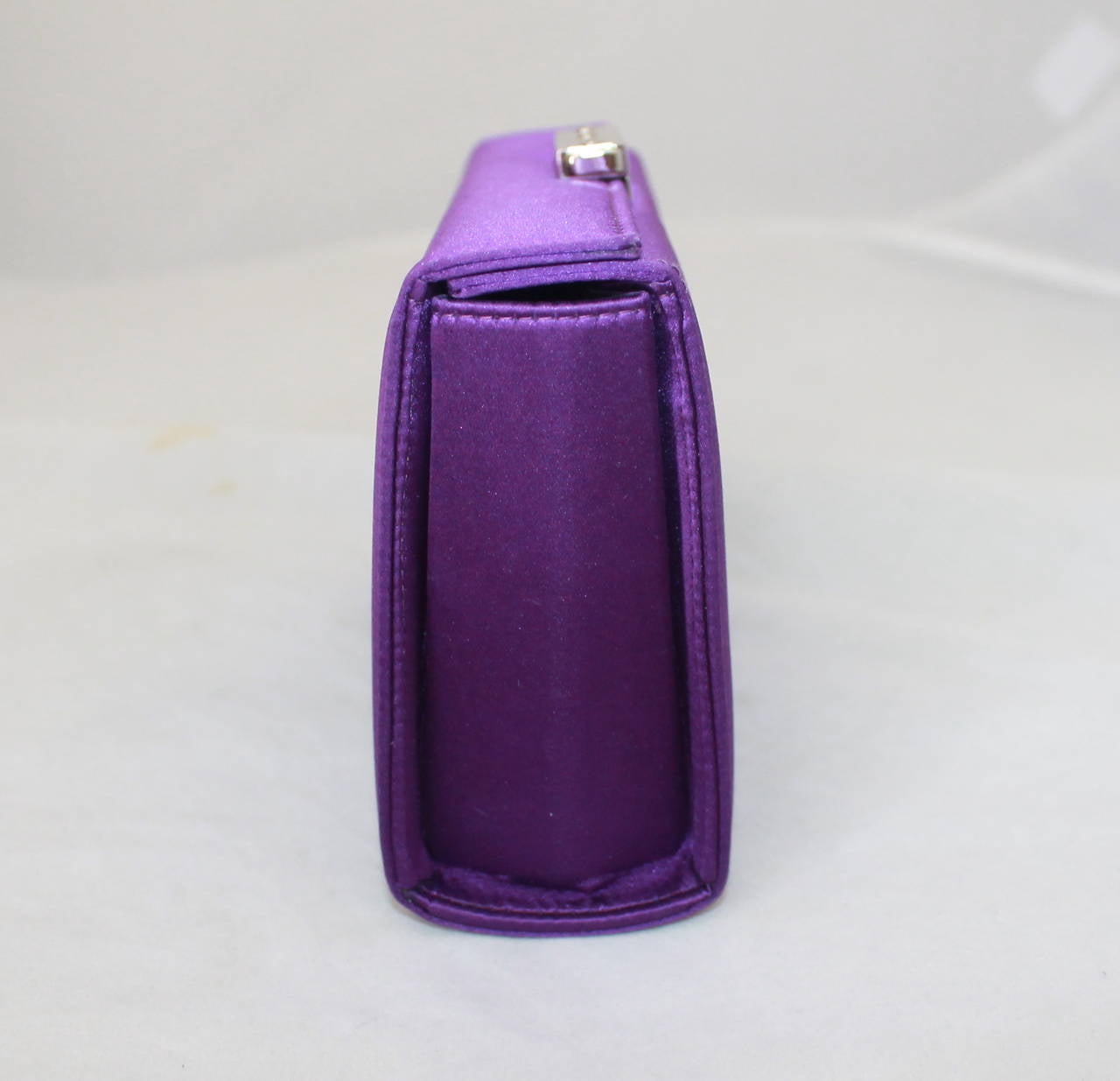 Ralph Lauren Collection Purple Satin Clutch. This clutch is in very good condition with minor wear, mainly on the inside. The bag has silver hardware. 

Measurements:
Height- 4