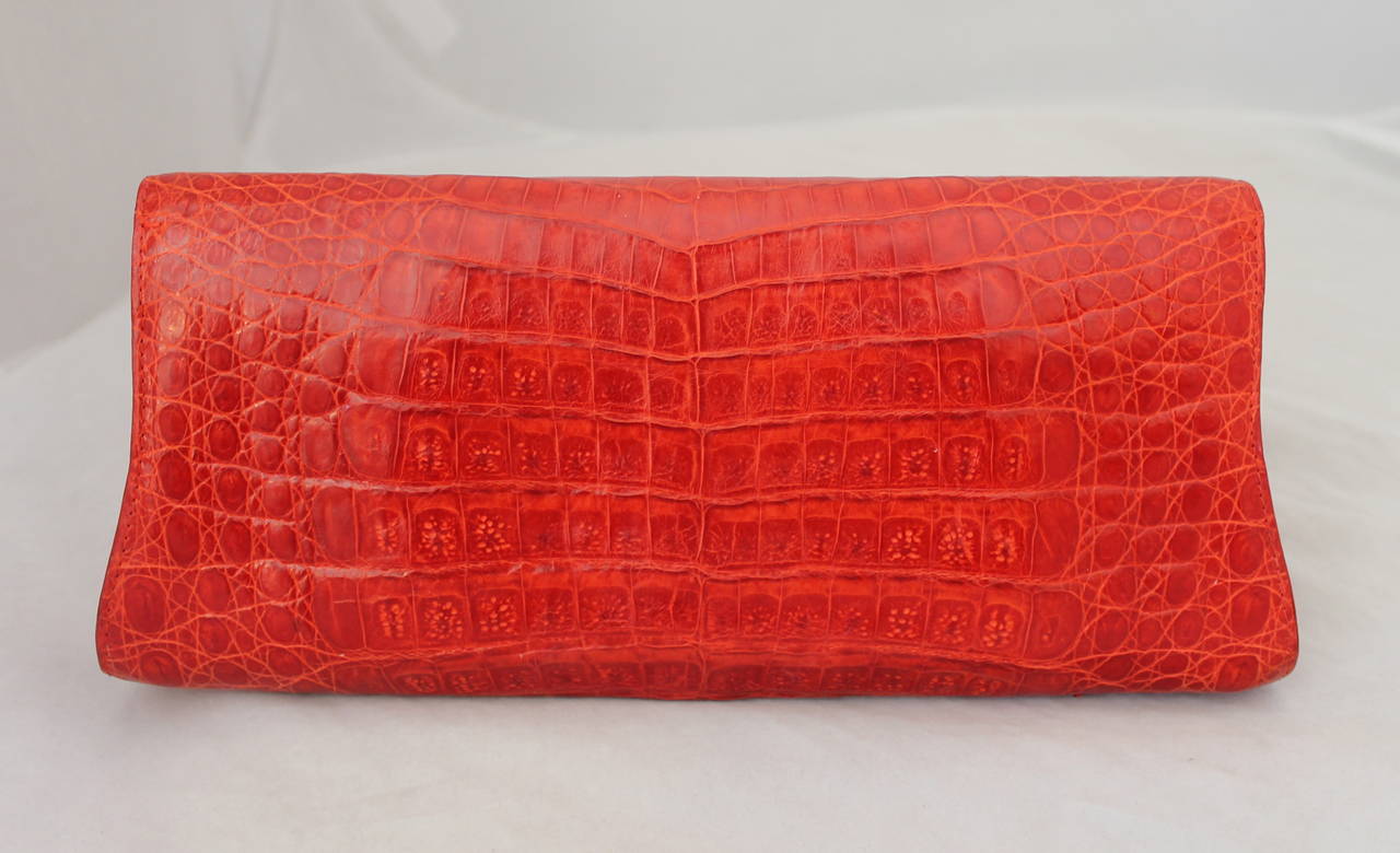 Nancy Gonzalez Red Crocodile Diagonal Edge Foldover Clutch with Suede Lining.

Measurements:
Length: 11 