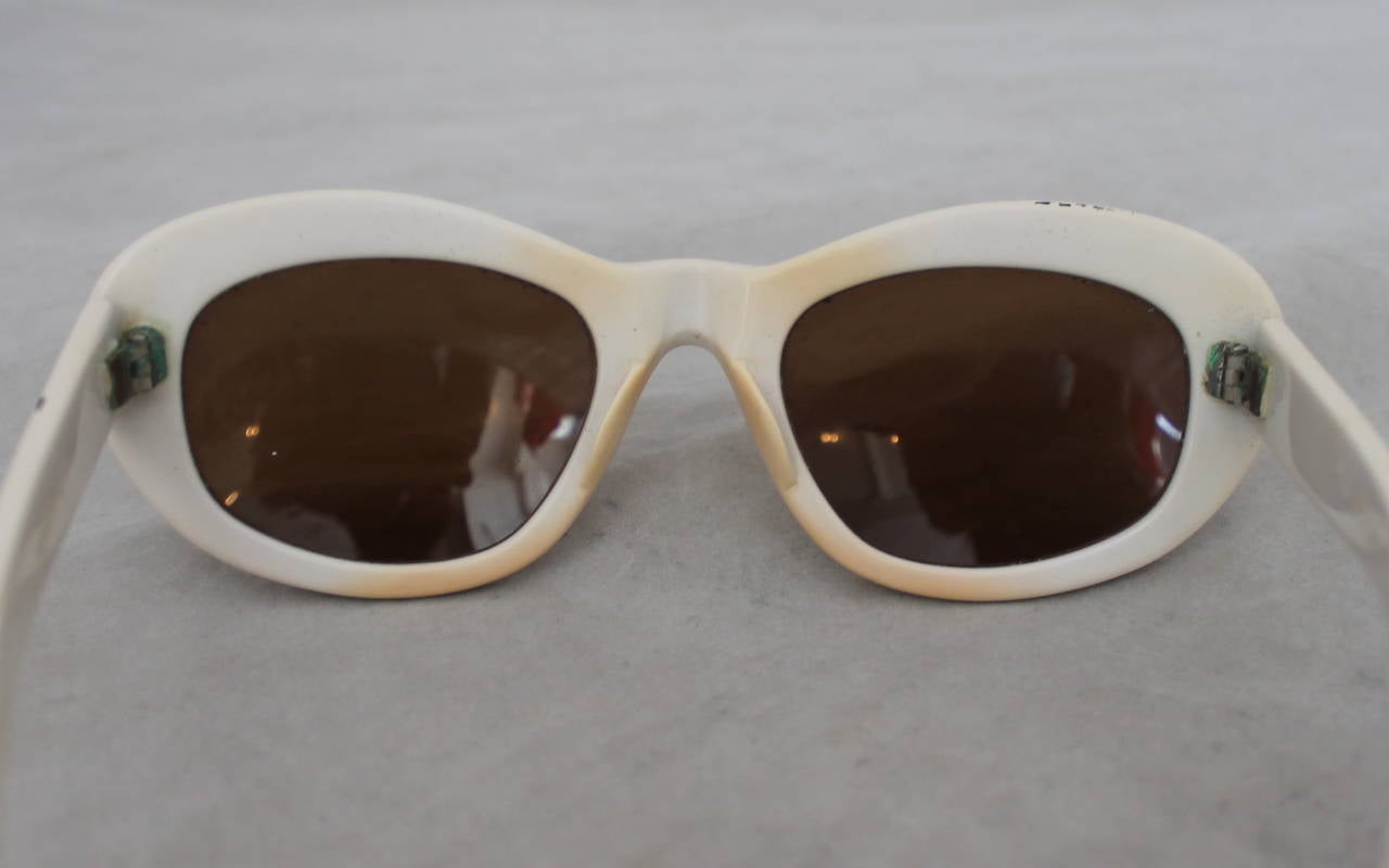 Azzedine Alaia 1990's Vintage White Frame Sunglasses. These sunglasses are in fair condition and have wear on them due to age. On the inside of the frame there is staining from makeup seen on image 2-5. There are two minor spots where the paint is