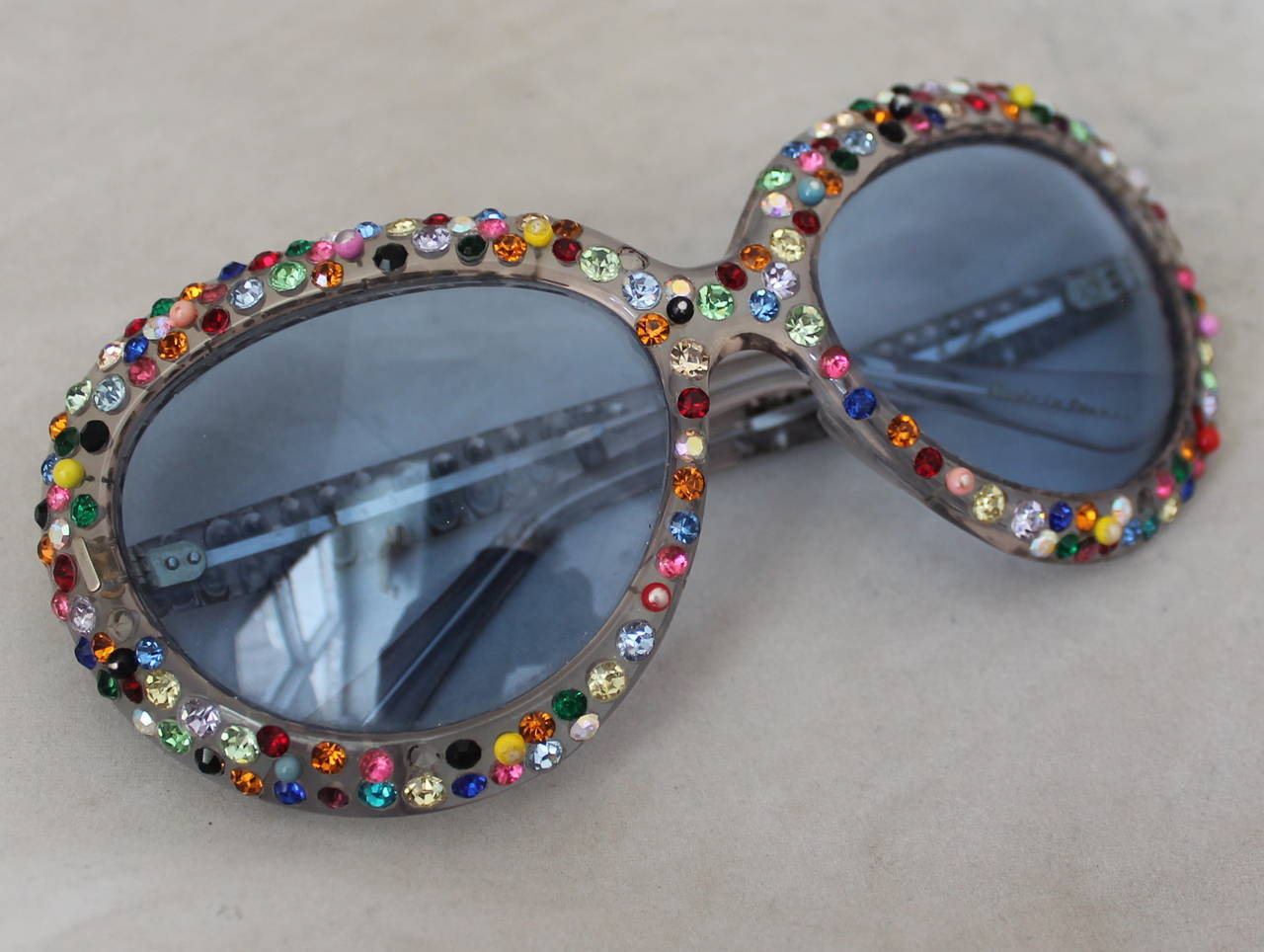 Main EGF 1960's Vintage Multi Rhinestone & Blue Frame Sunglasses. These sunglasses are in good vintage condition with the only being that of rhinestones missing, however it is only seen upon close examination. The left leg has 1 missing, the right