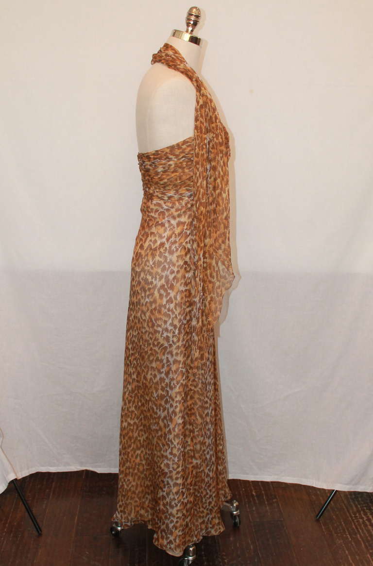 Vicky Tiel leopard print silk chiffon gown. This gown is strapless and comes with a shawl. It is in excellent condition and a size 6.
Measurements:
Bust- 35